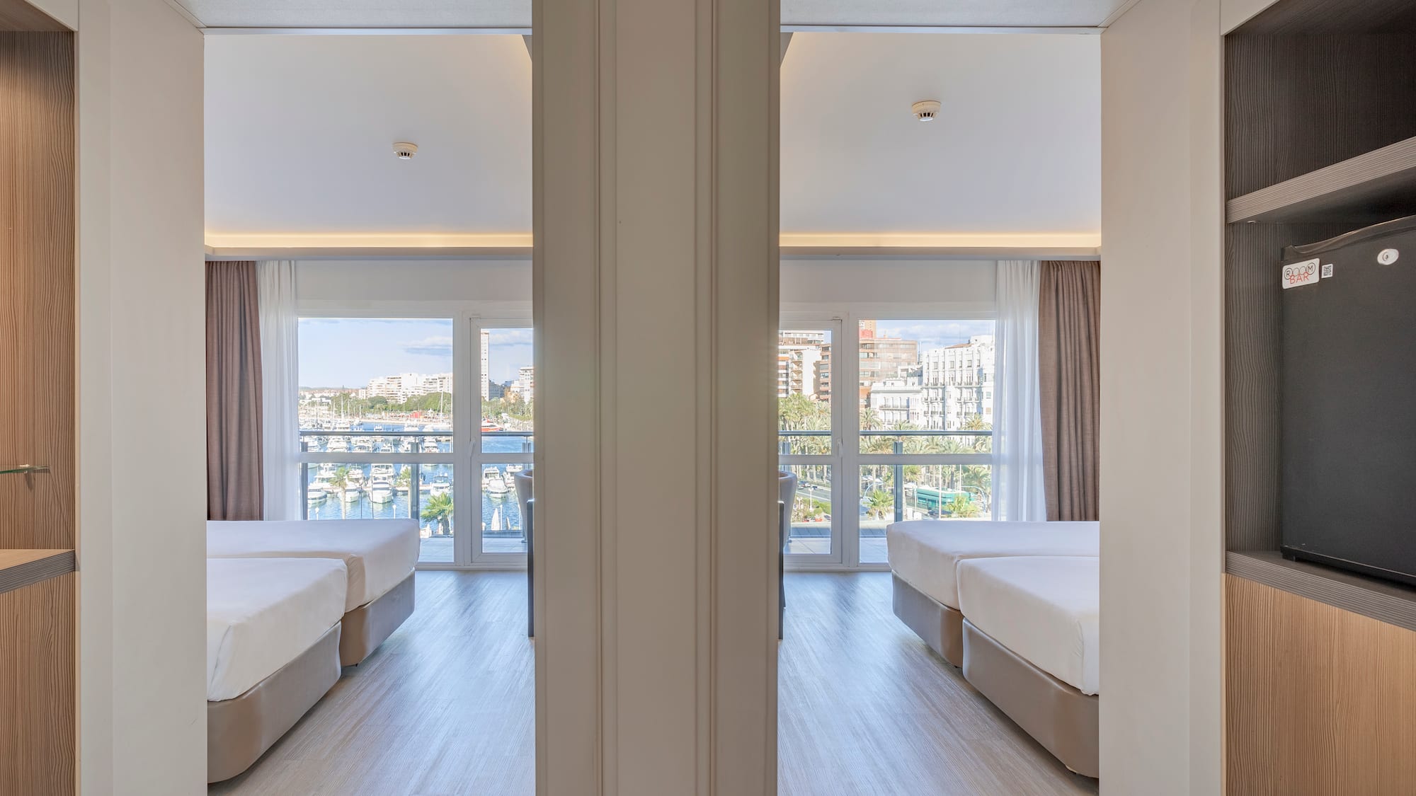 a room with two beds and a window