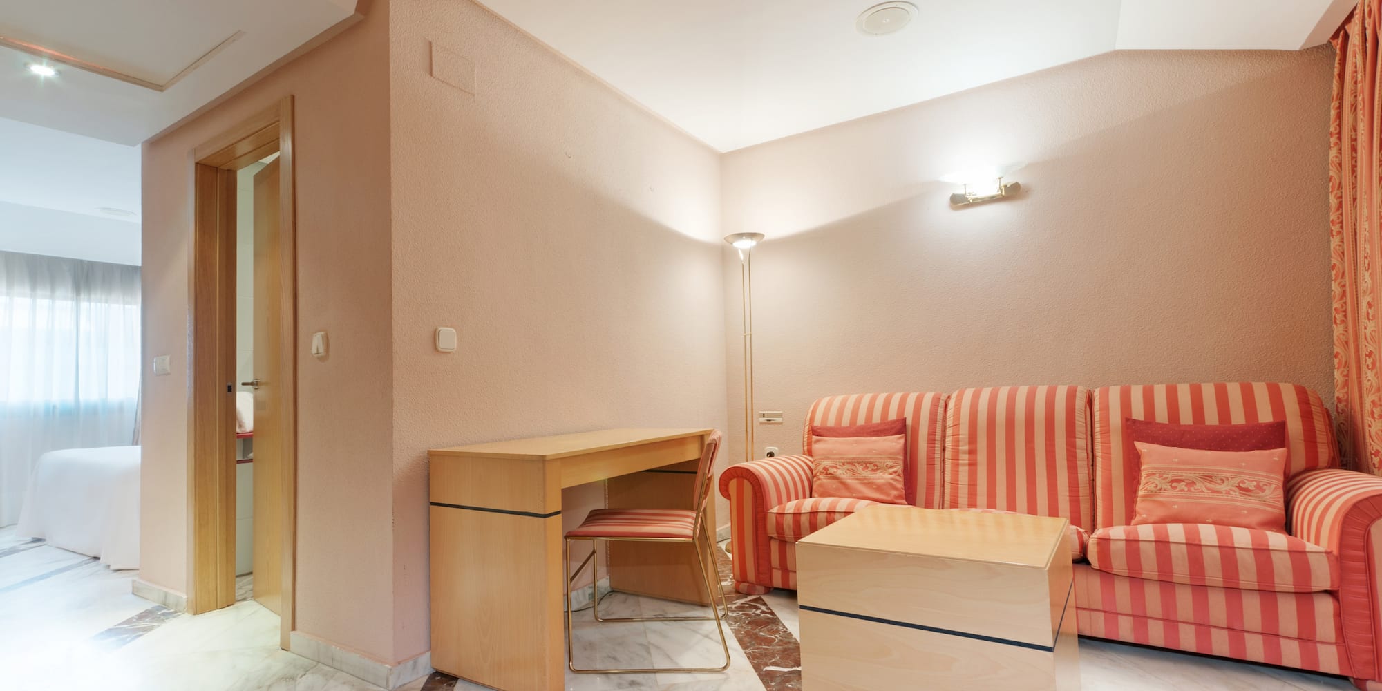 a room with a couch and a desk