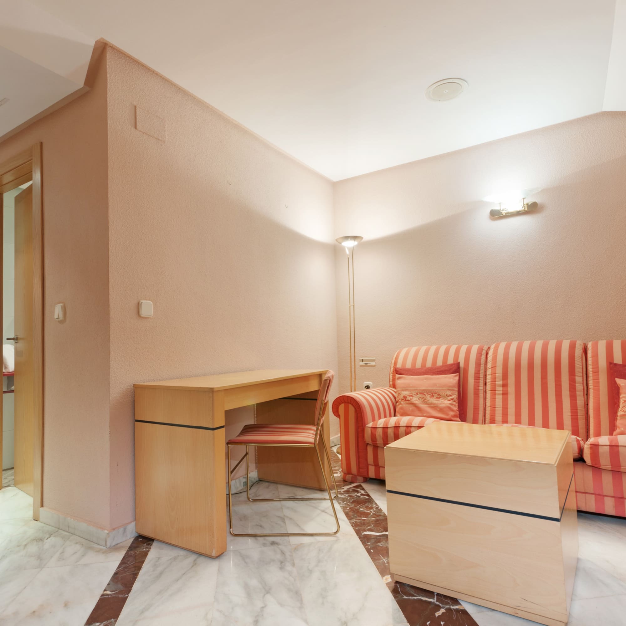 a room with a couch and a desk