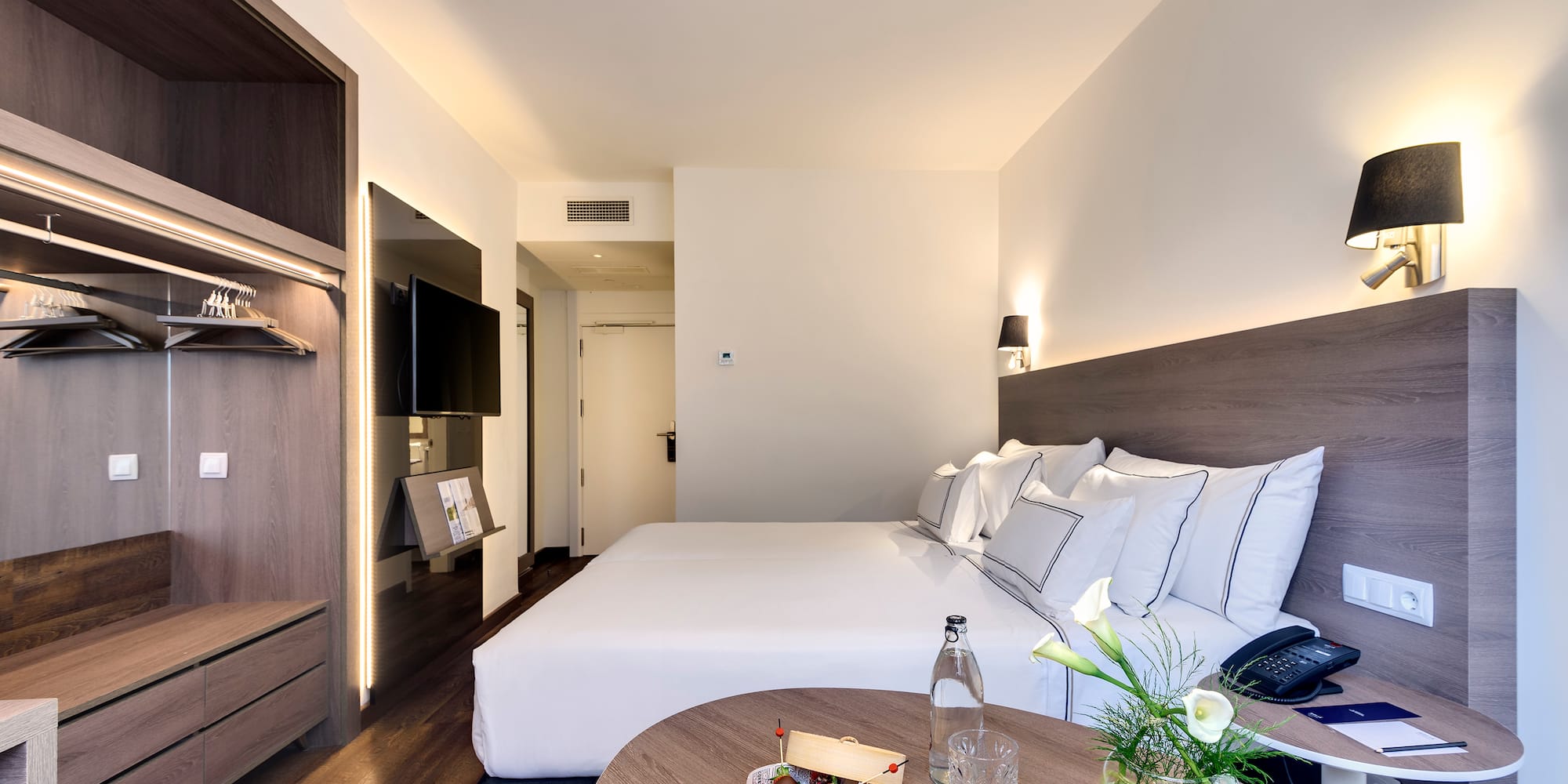 a hotel room with a bed and a table