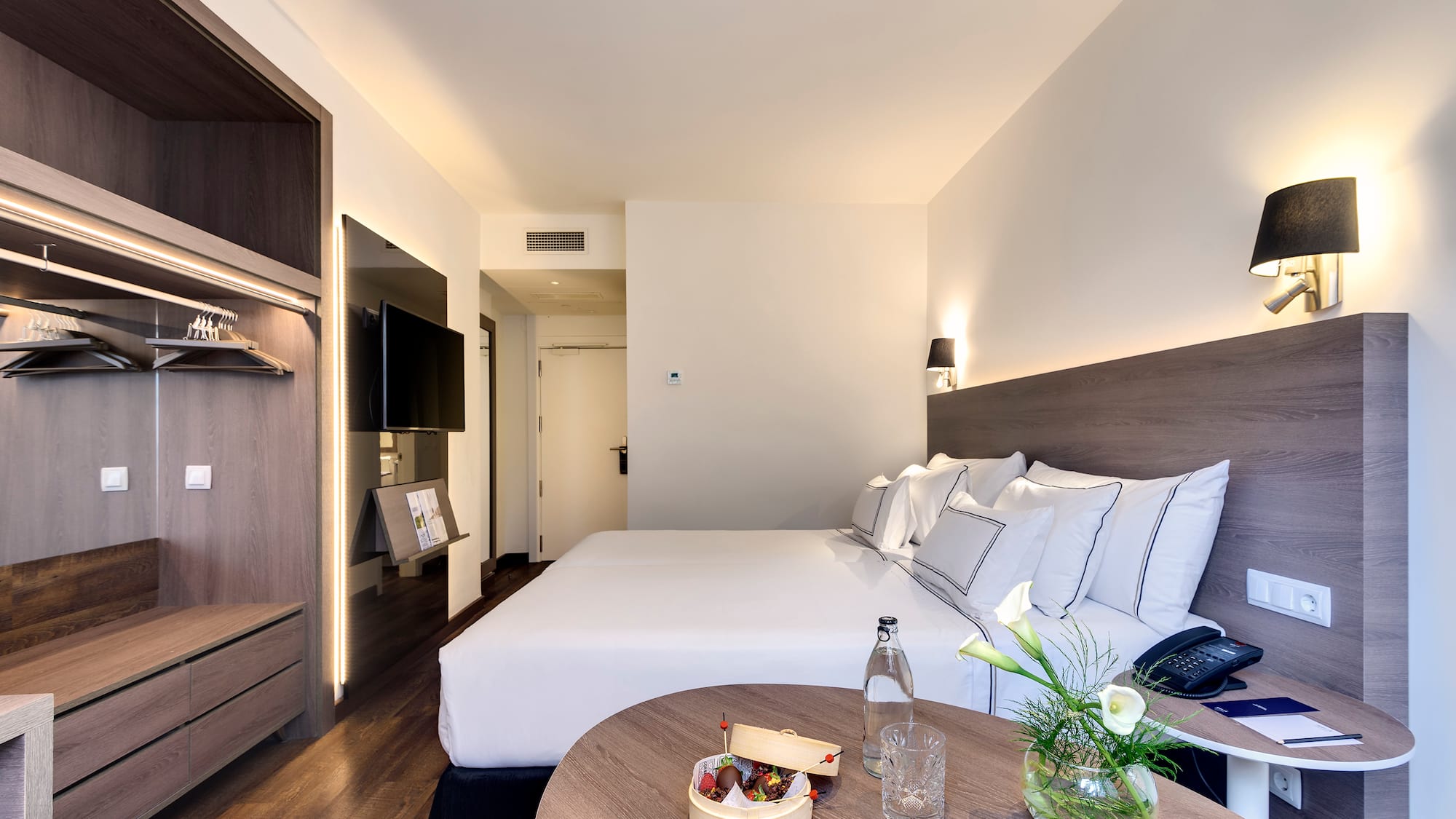 a hotel room with a bed and a table