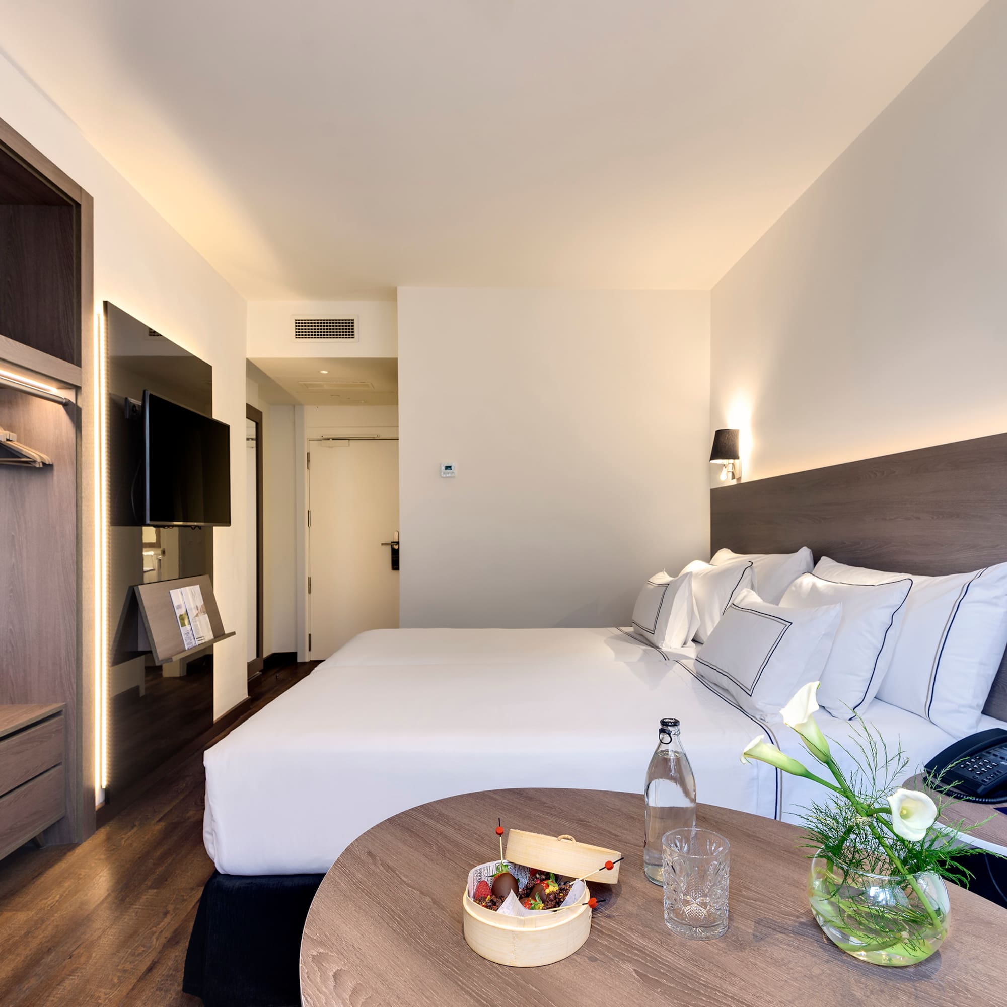 a hotel room with a bed and a table