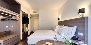 a hotel room with a bed and a table