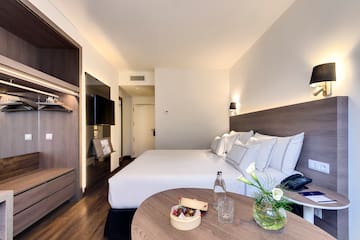 a hotel room with a bed and a table