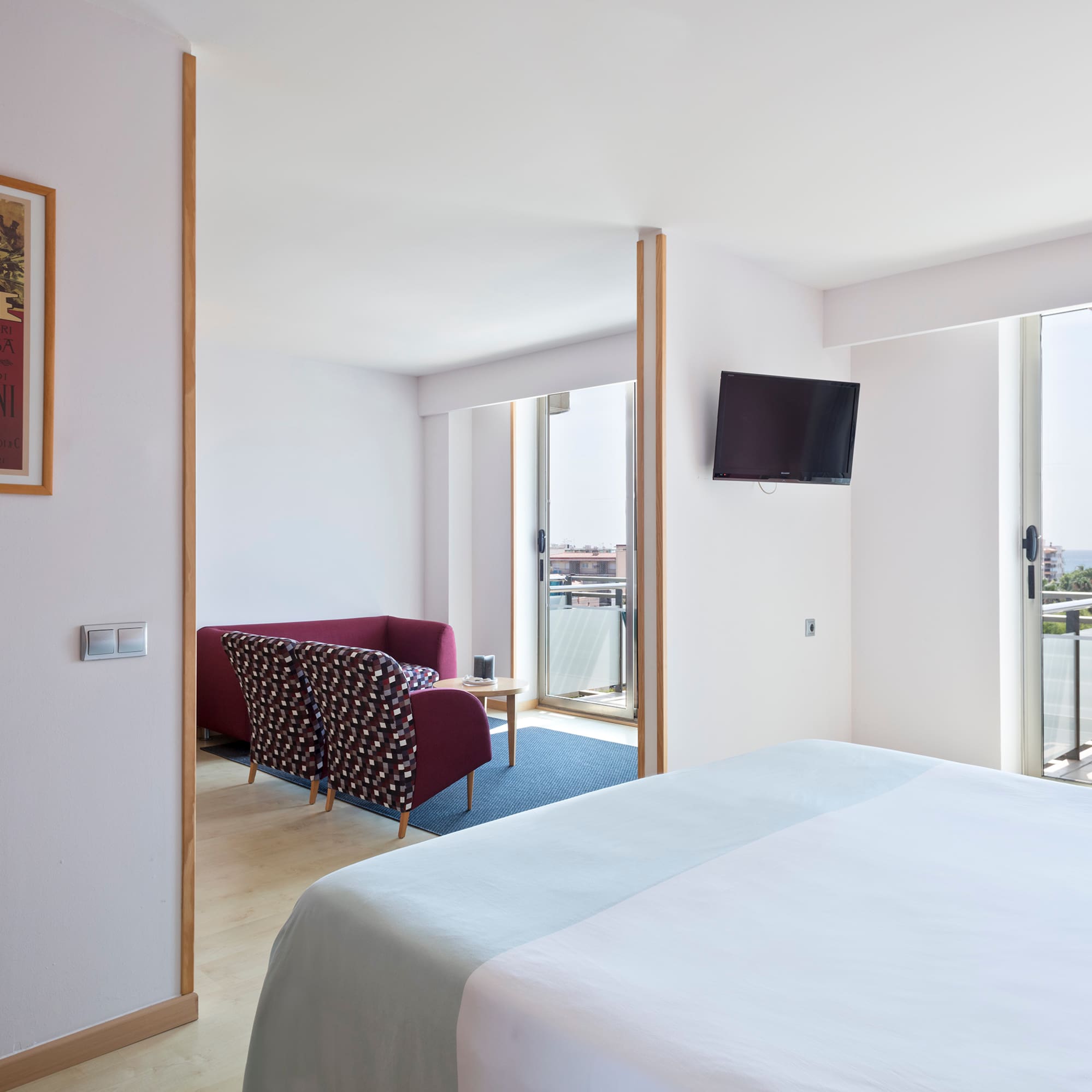 a bedroom with a bed and a television