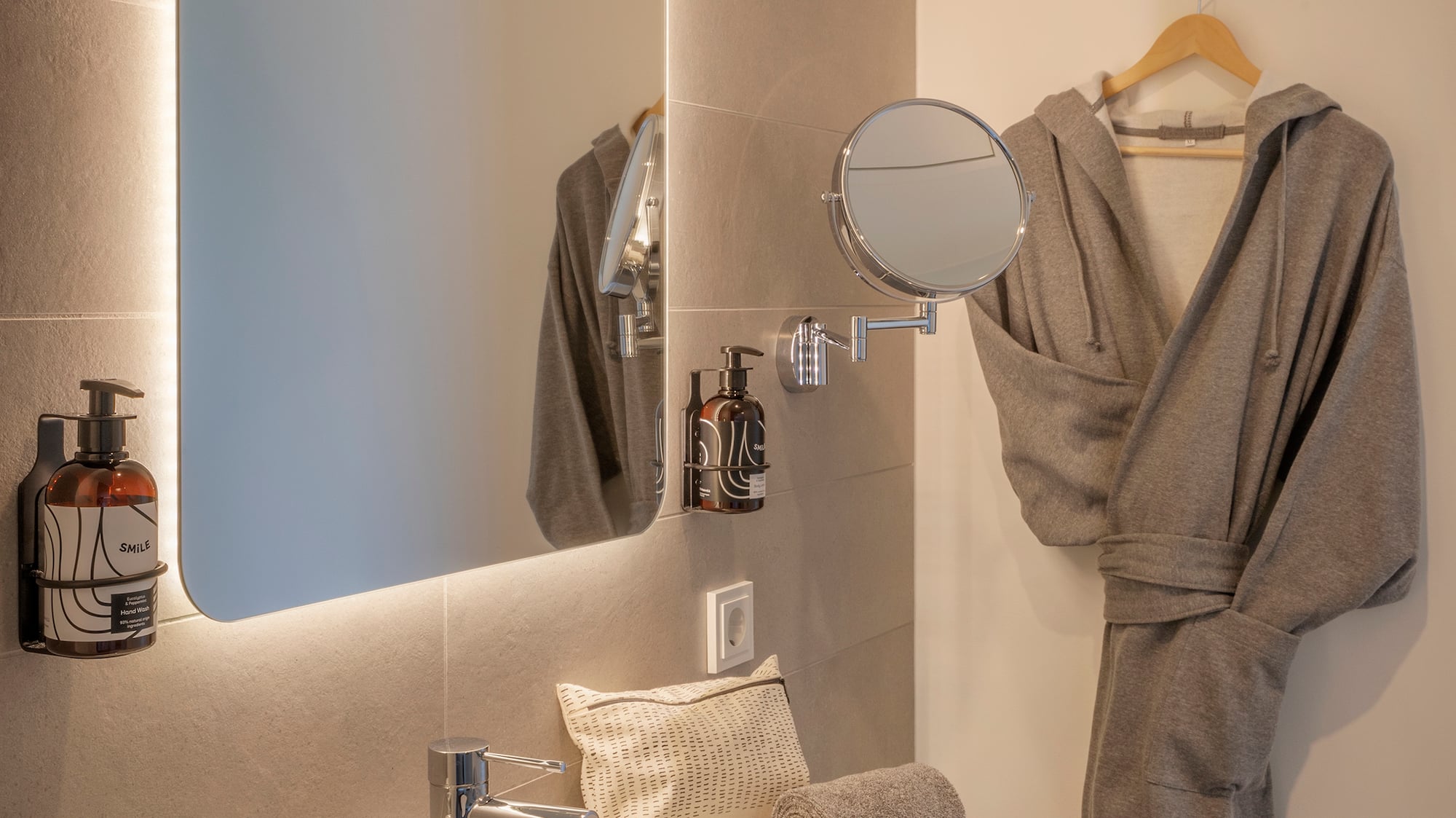 a bathroom with a bathrobe and a mirror