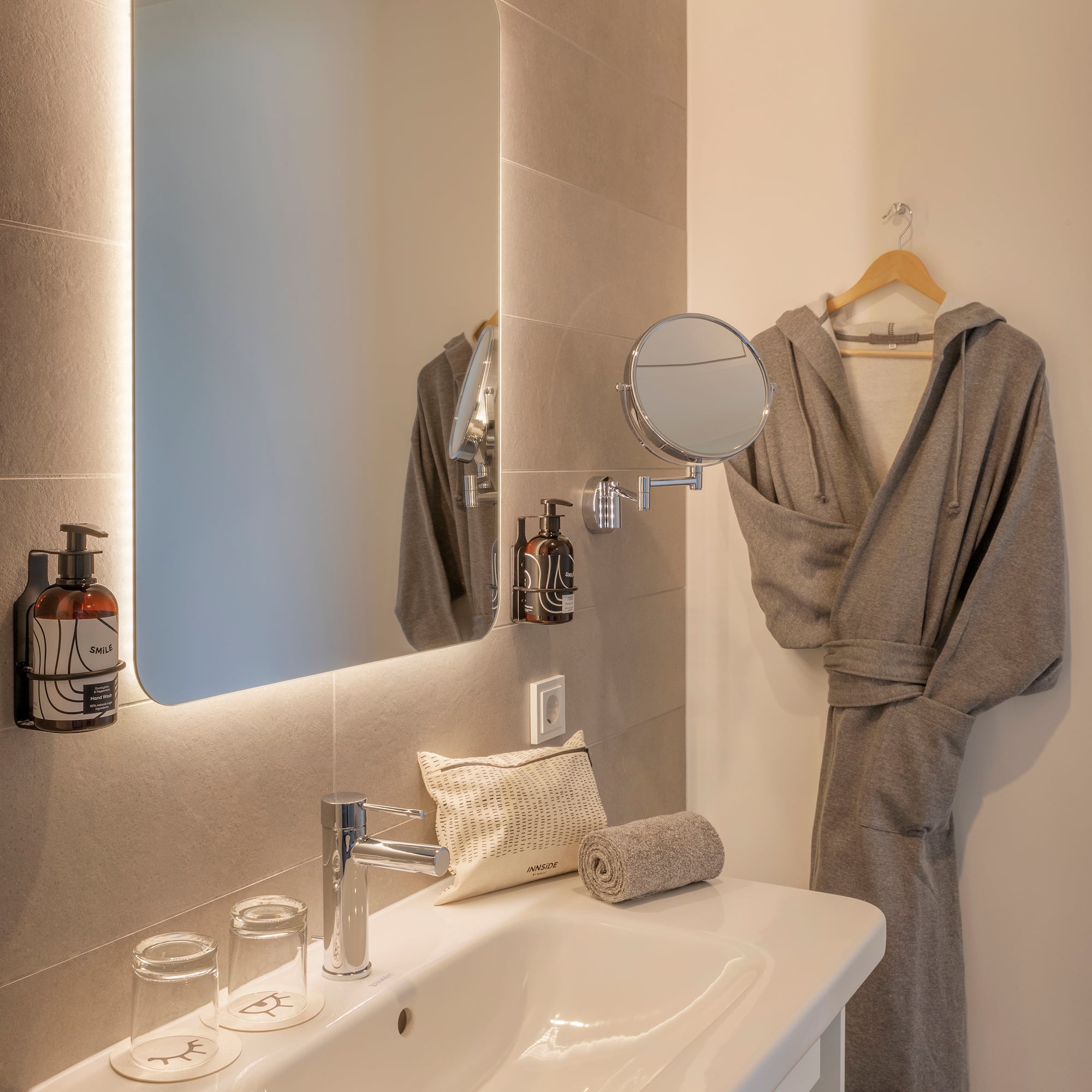 a bathroom with a bathrobe and a mirror