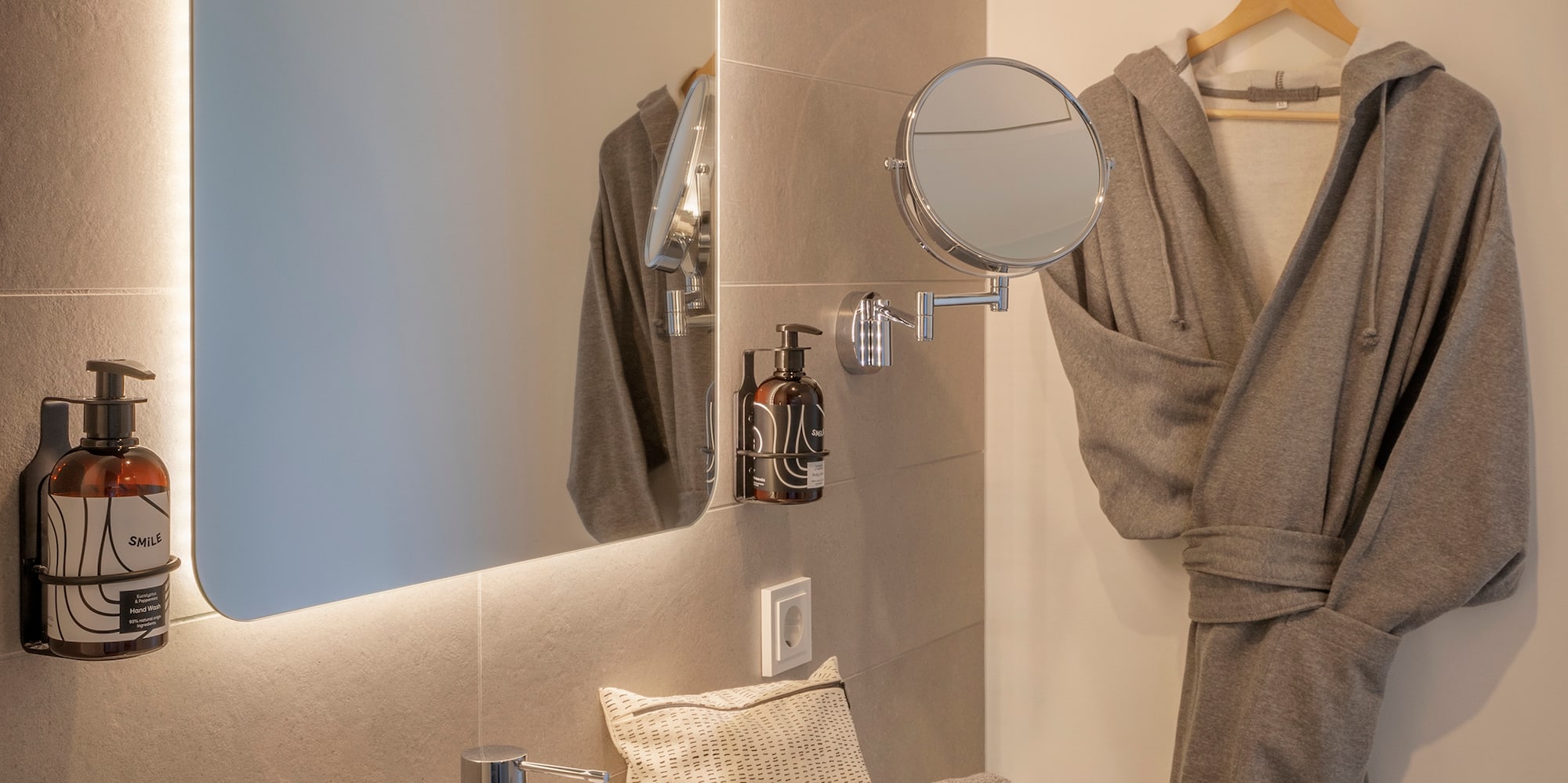 a bathroom with a bathrobe and a mirror