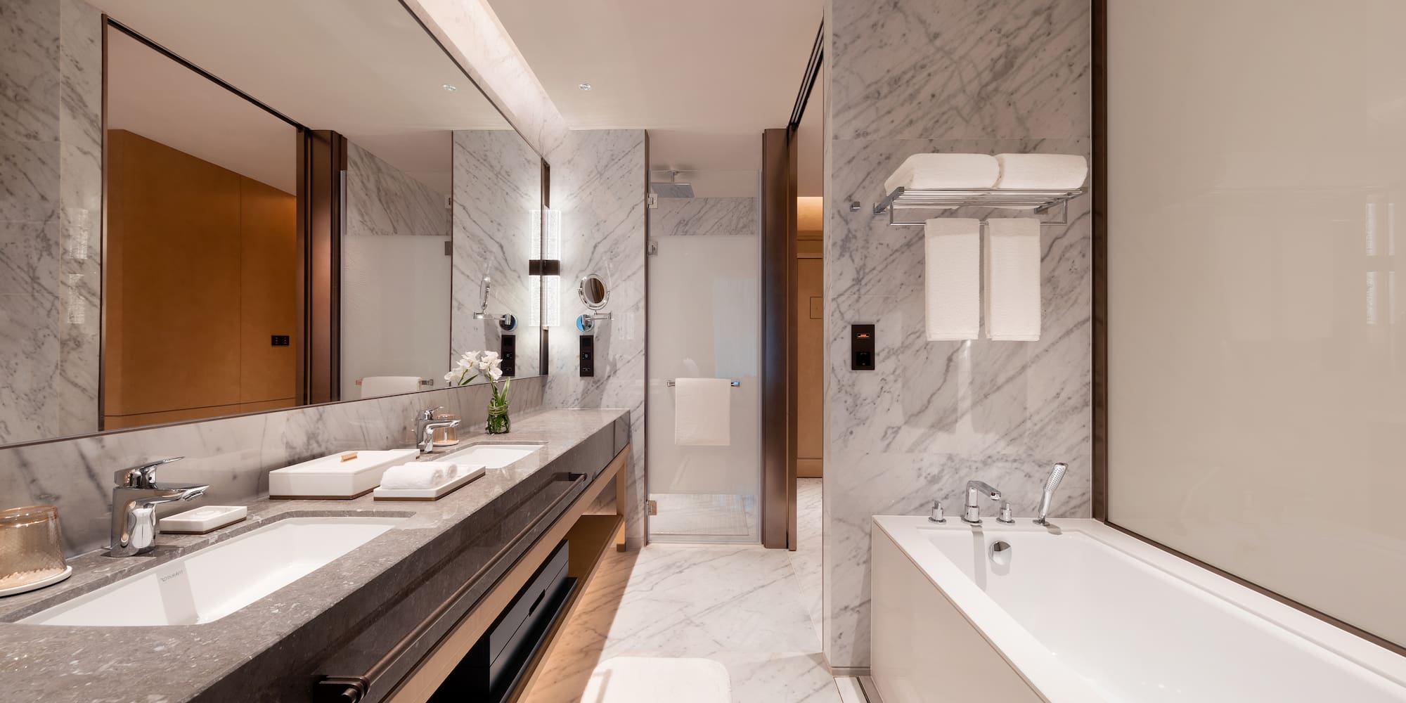 a bathroom with marble walls and a bathtub