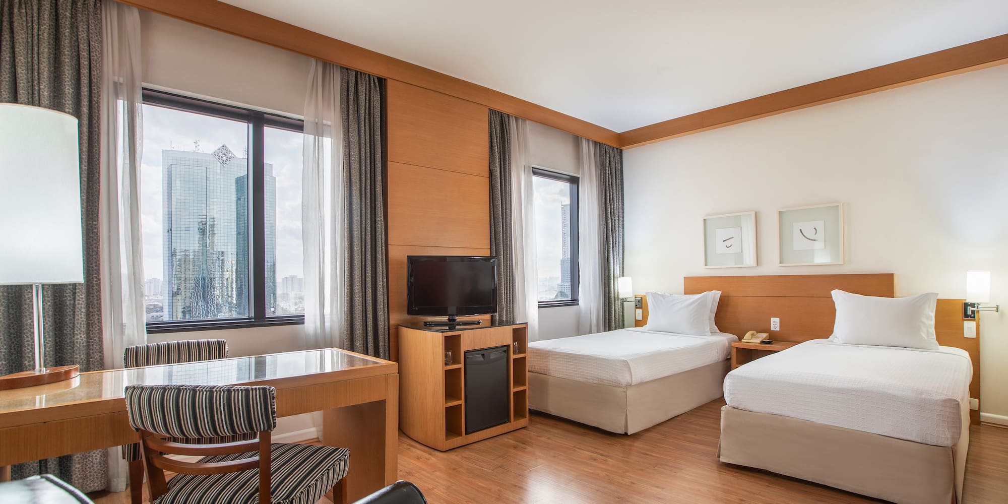 a room with two beds and a desk