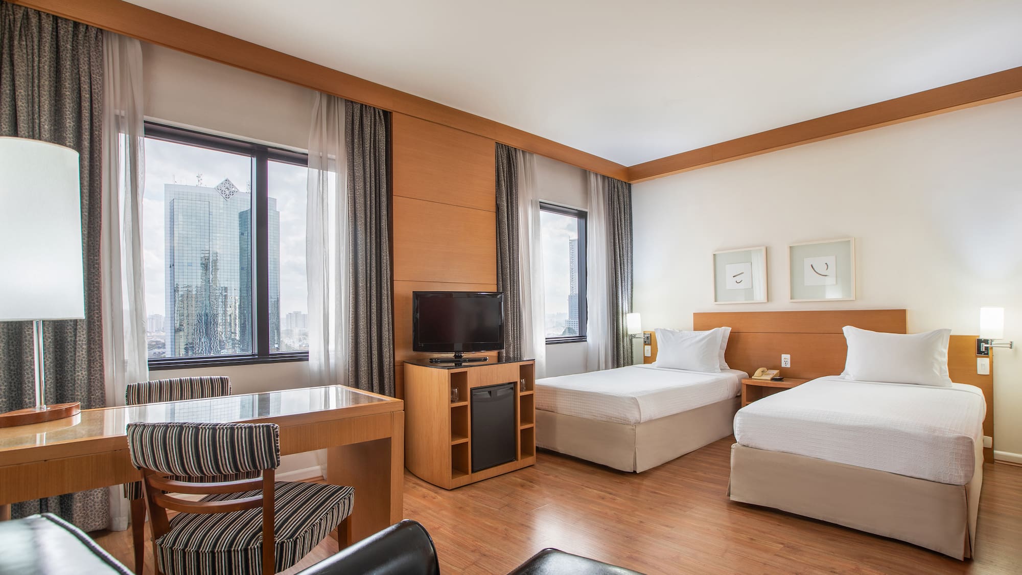 a room with two beds and a desk