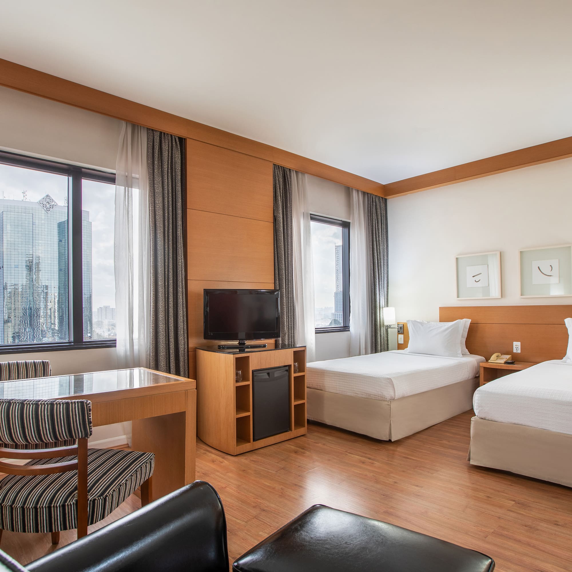 a room with two beds and a desk