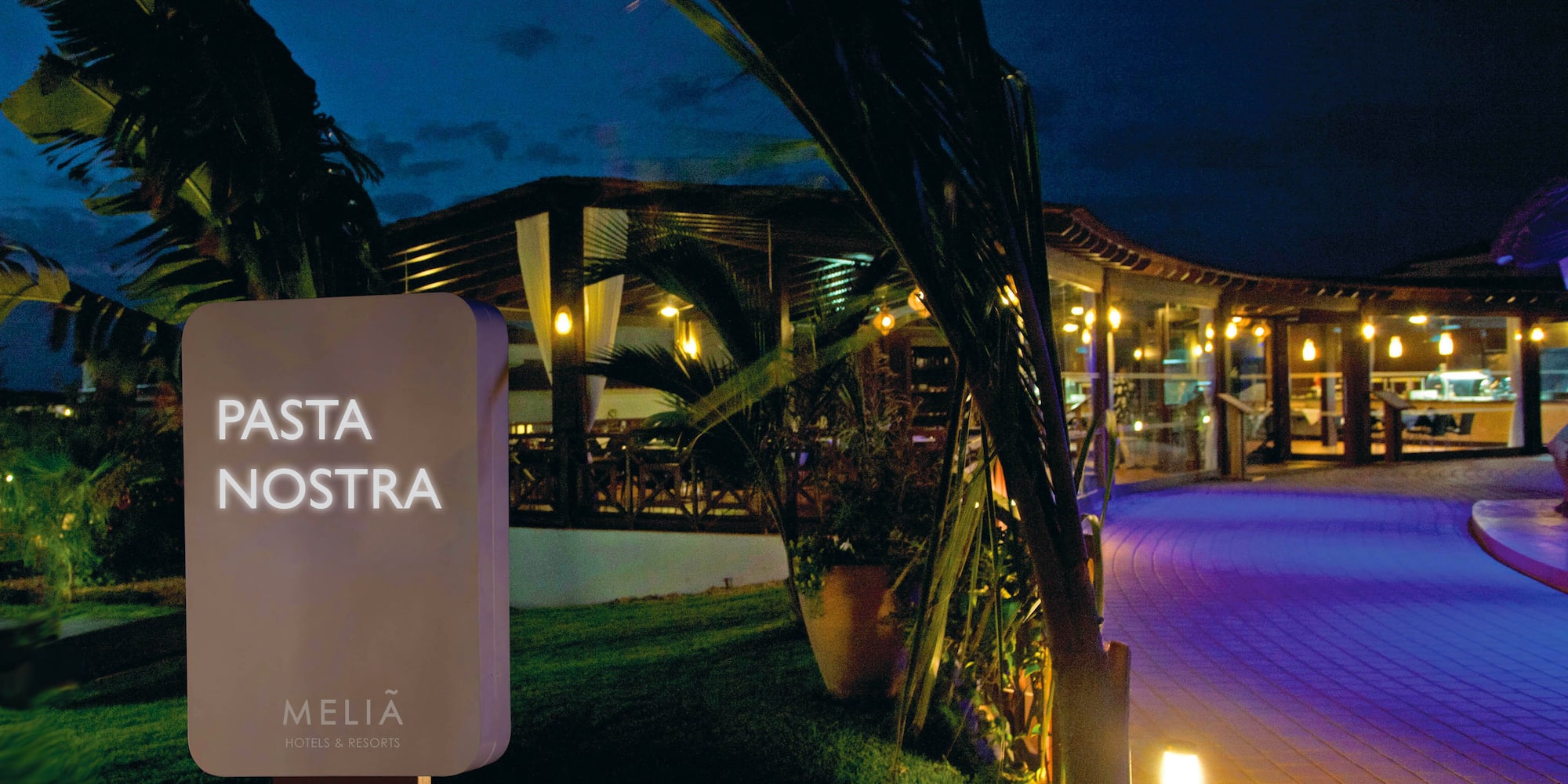 a sign on a pole with lights on it