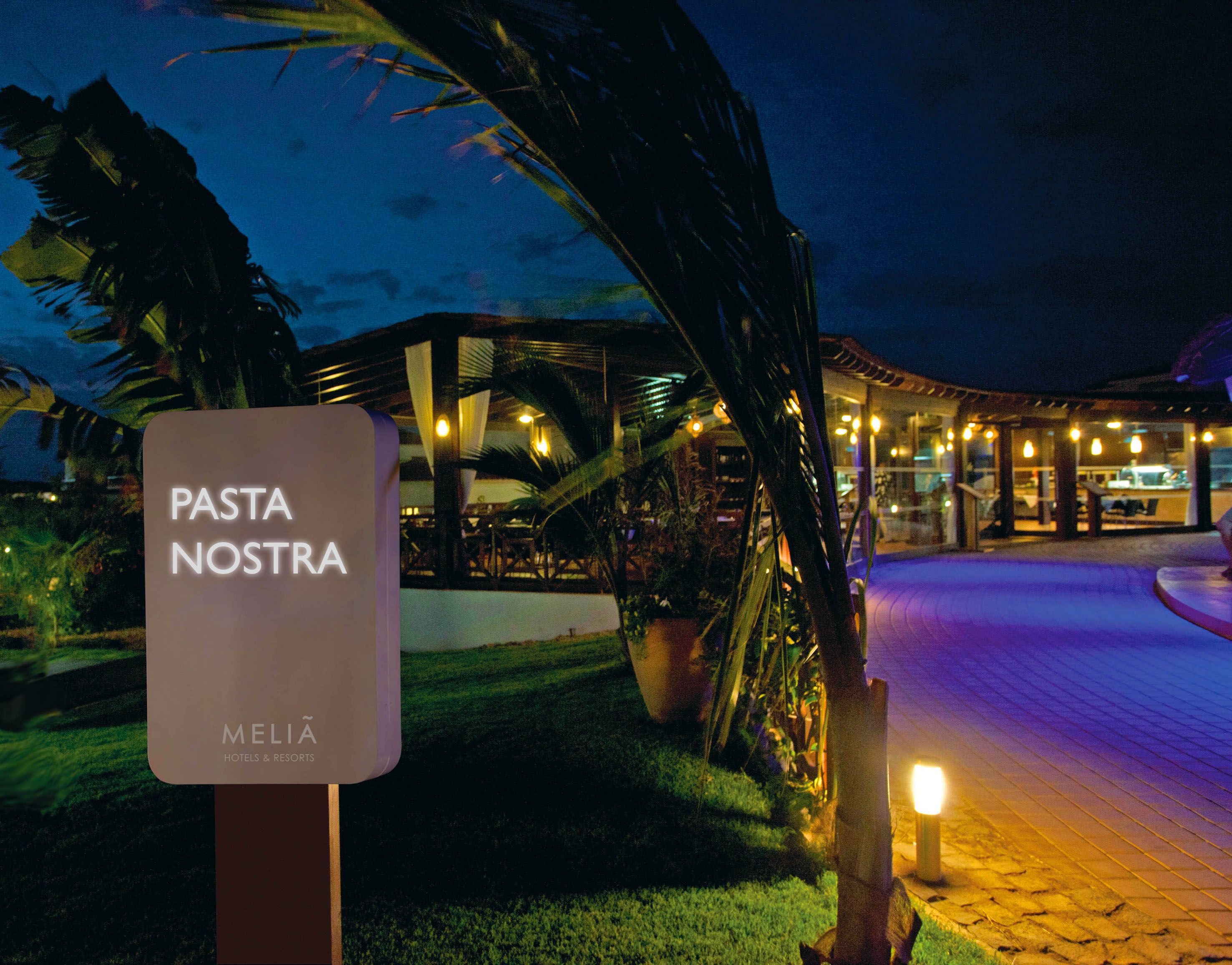 a sign on a pole with lights on it