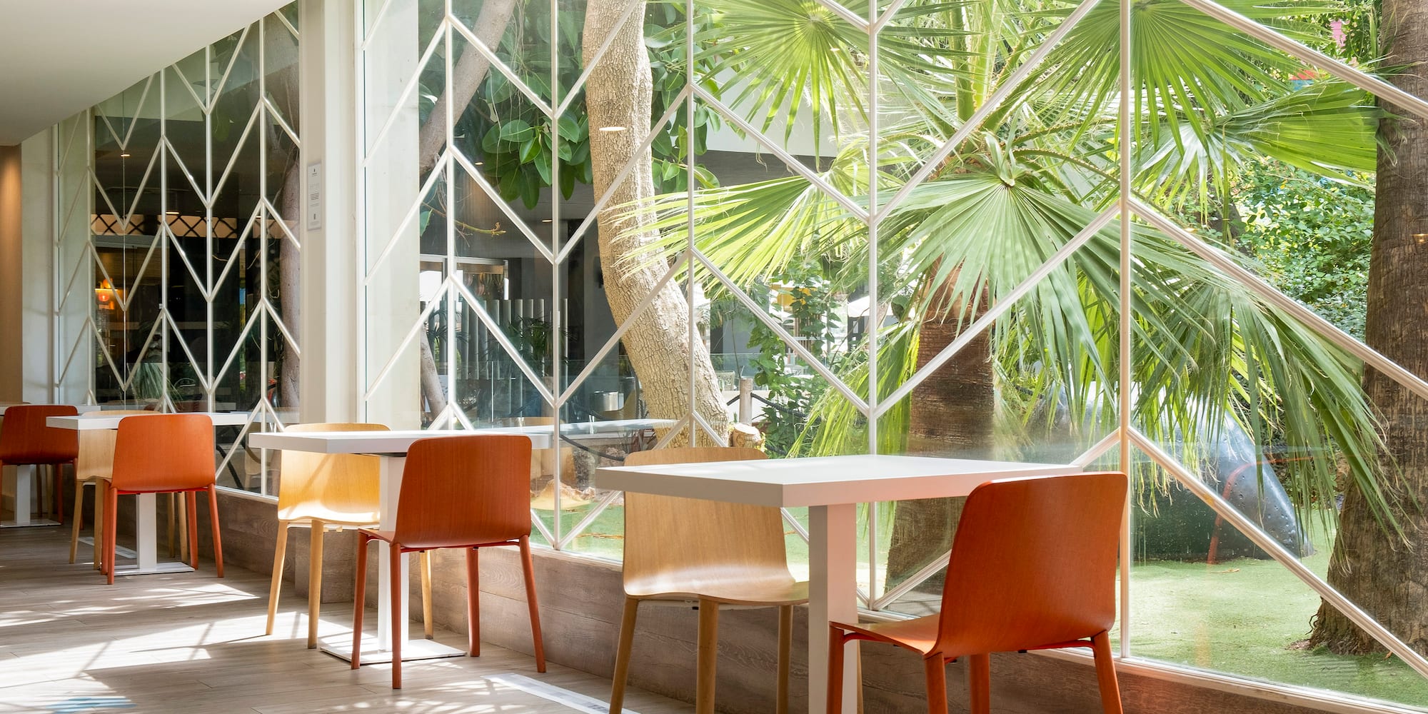 a table and chairs in a room with a window