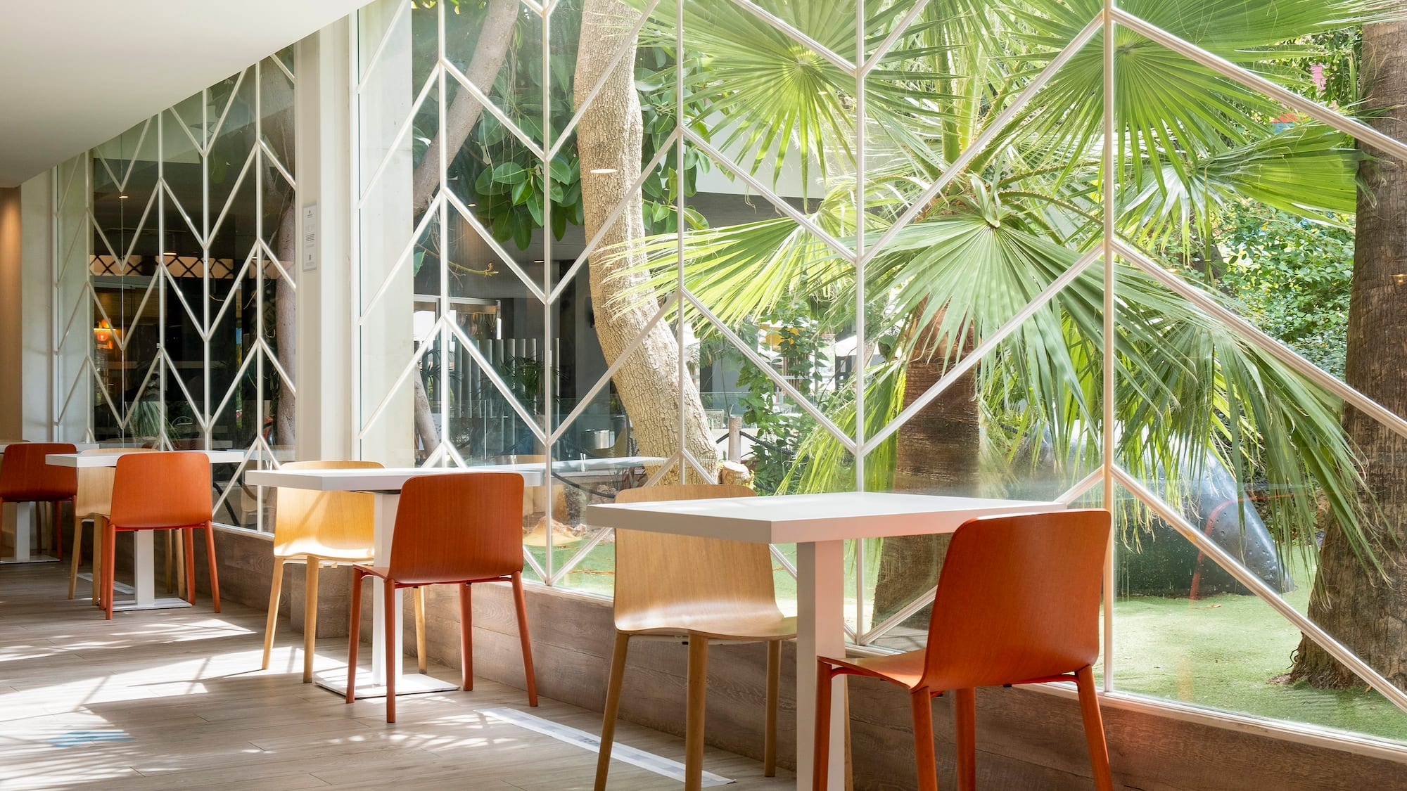 a table and chairs in a room with a window