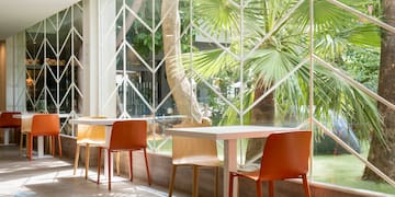 a table and chairs in a room with a window
