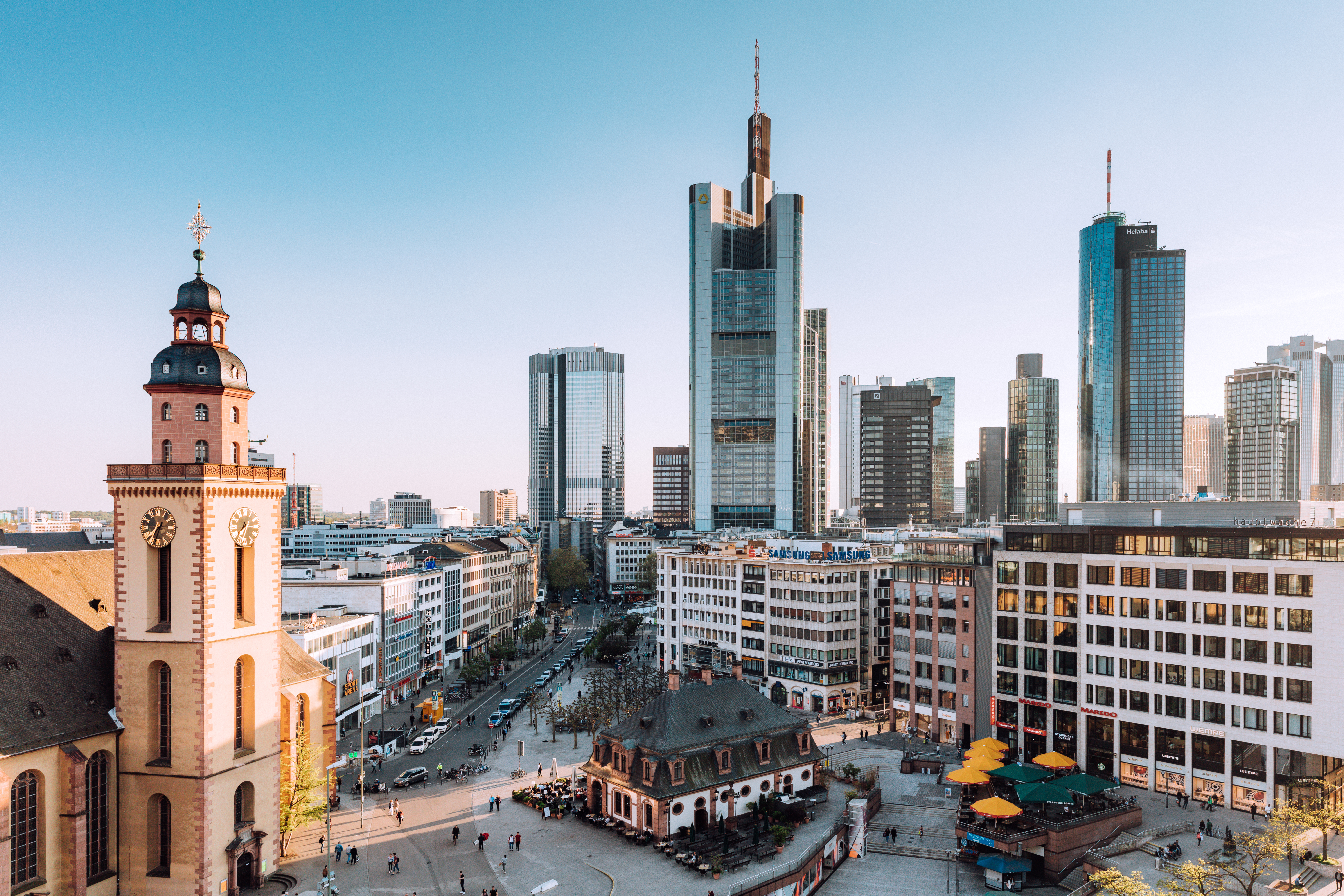 Frankfurt skyline with historic St. Catherine's Church and modern skyscrapers.