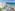 a swimming pool and a large building by the ocean