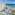 a swimming pool and a large building by the ocean