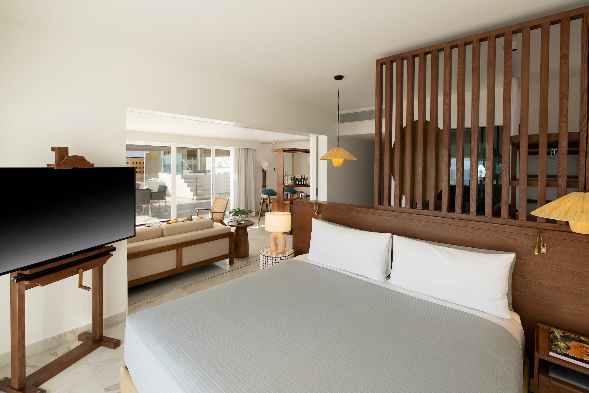 a room with a bed and a television