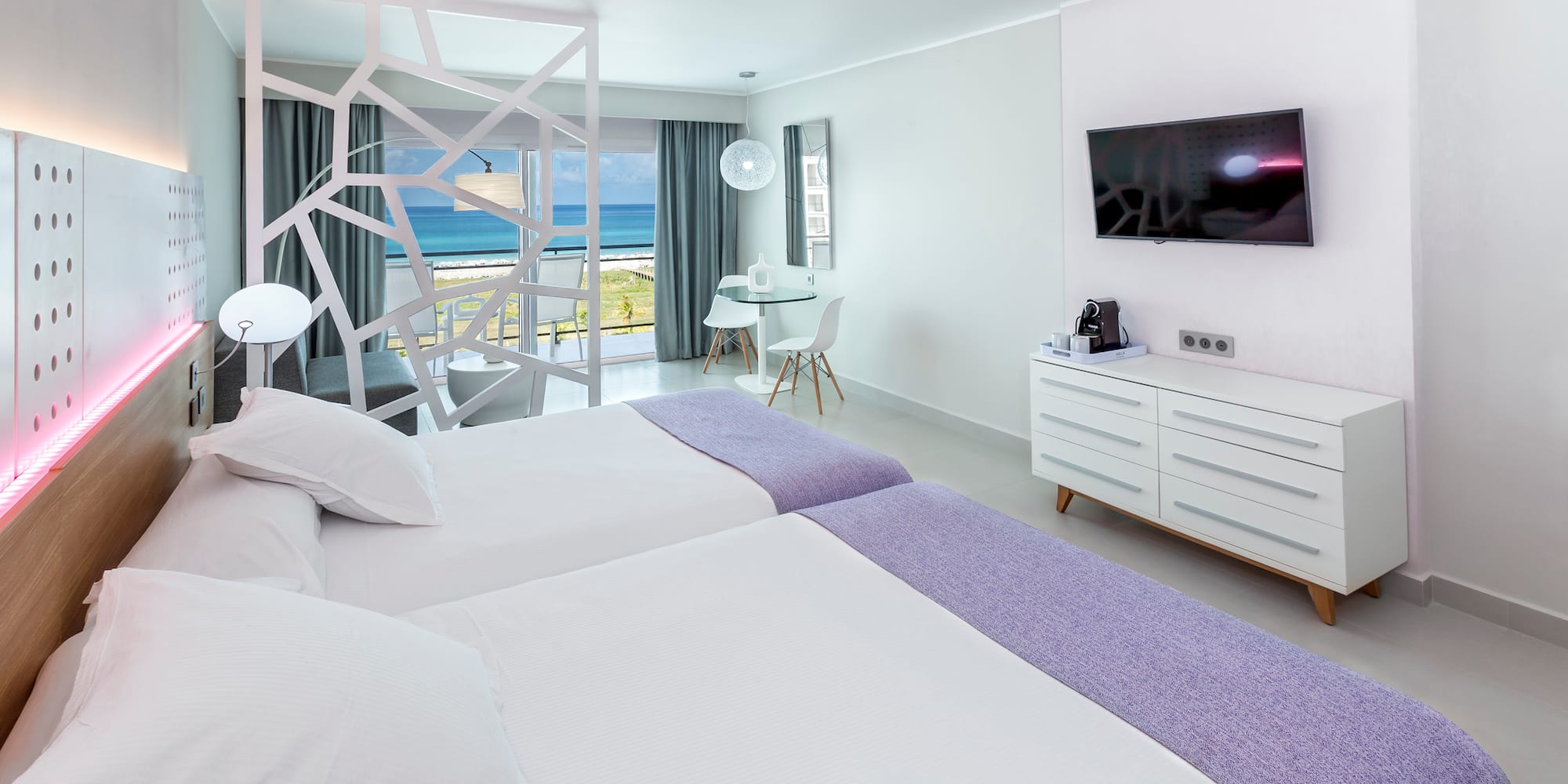 a room with two beds and a television