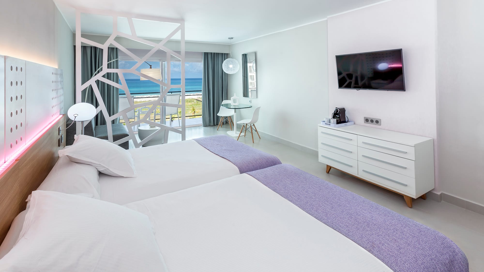 a room with two beds and a television