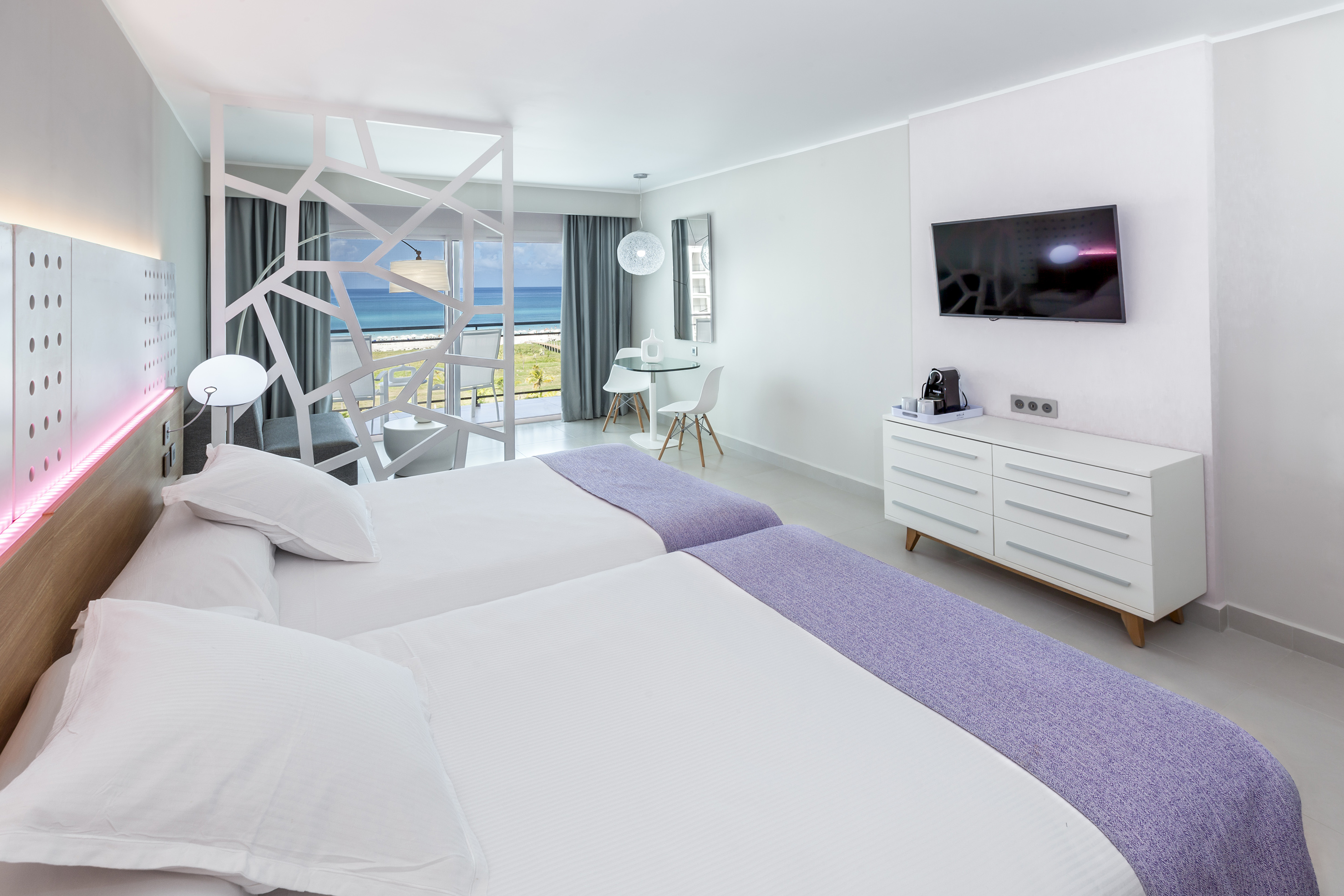 a room with two beds and a television