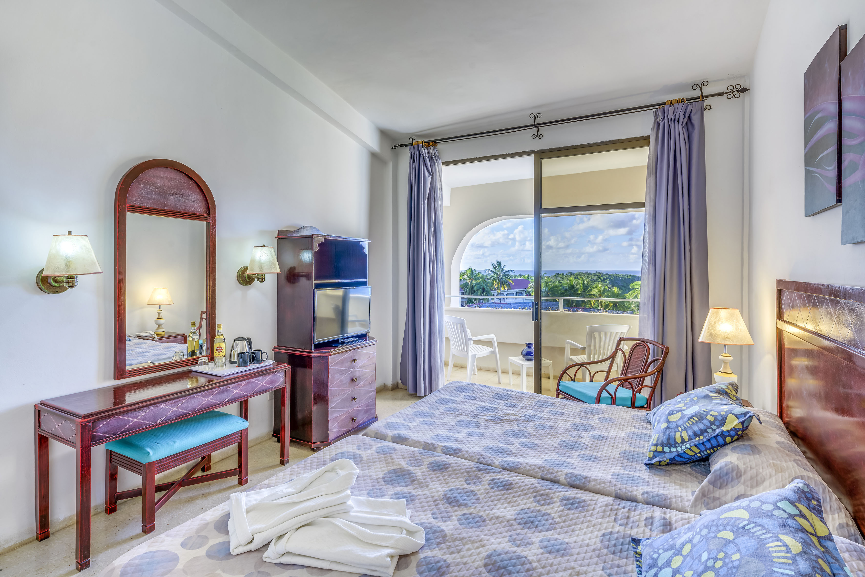 a bedroom with a large window and a bed