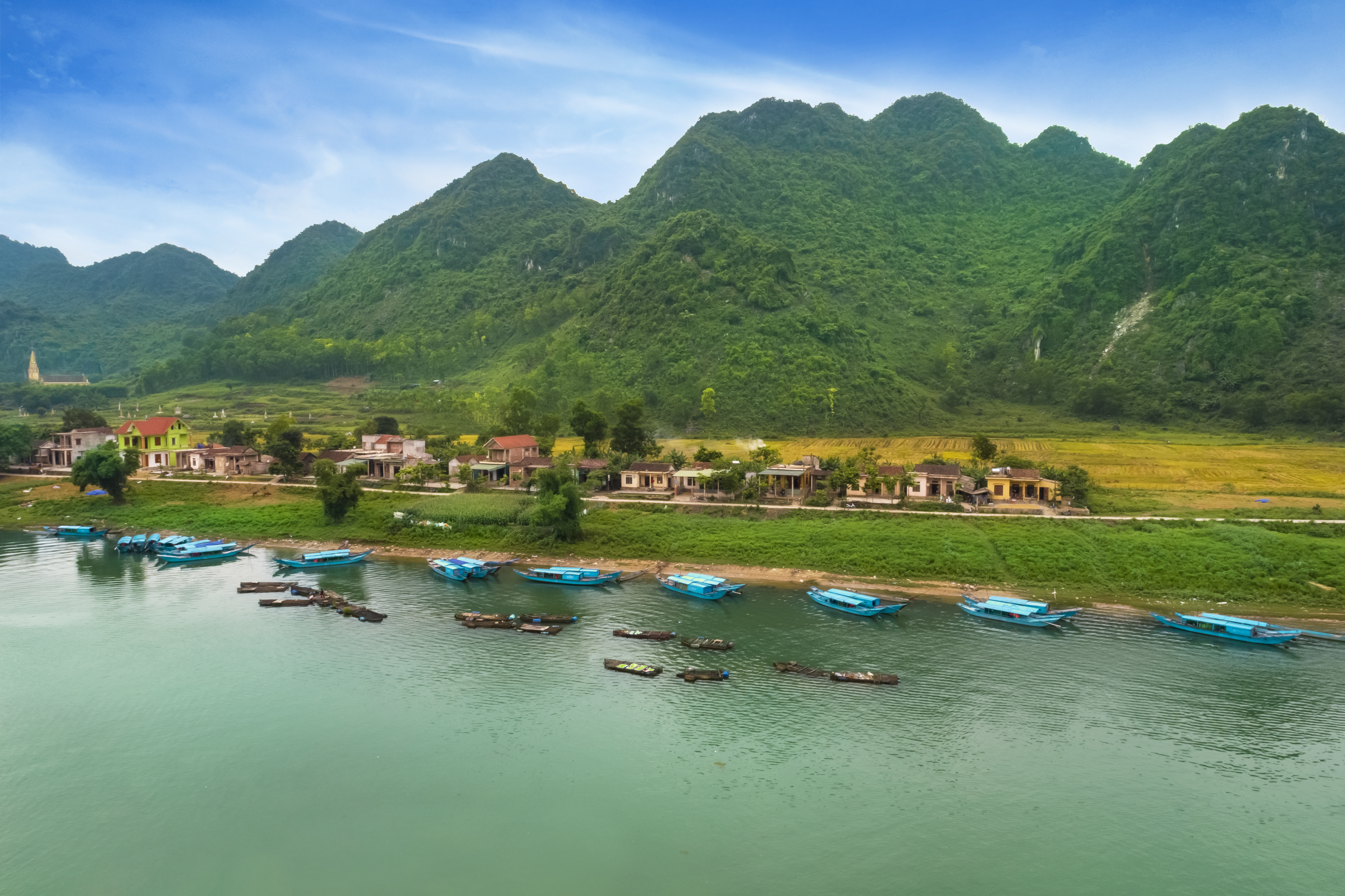 boats on the water next to a village