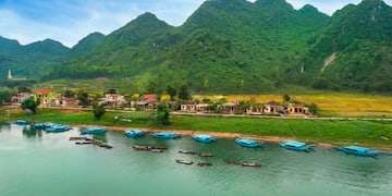 boats on the water next to a village