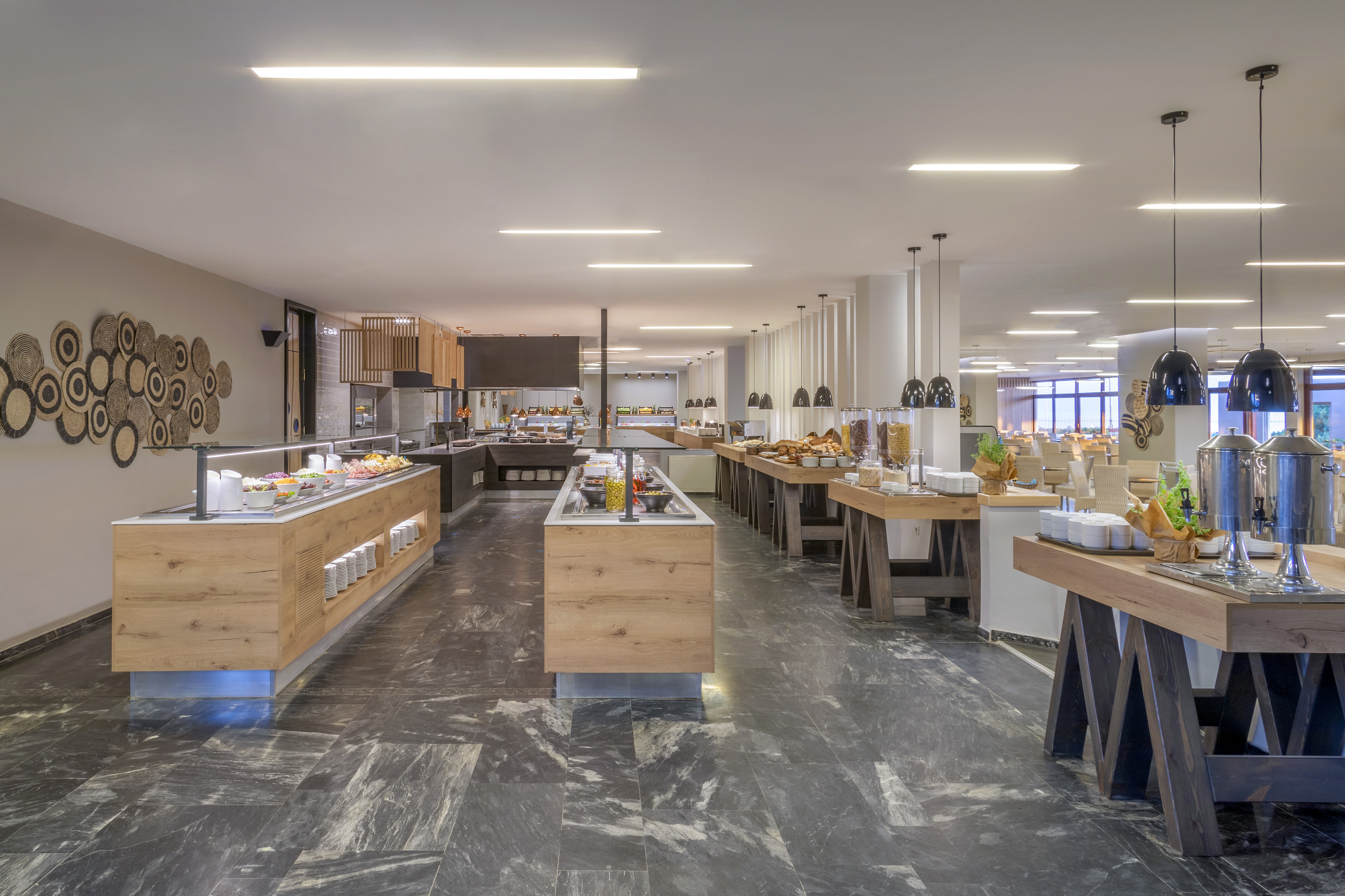 Spacious hotel buffet with various breakfast and food stations and modern design.