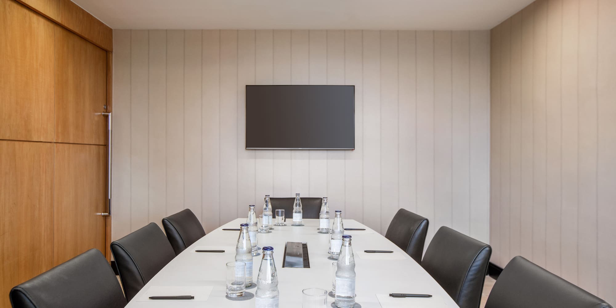 a table with chairs and bottles on it