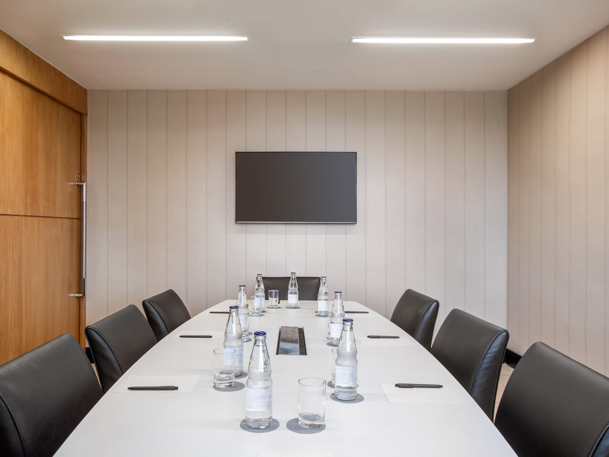 a table with chairs and bottles on it