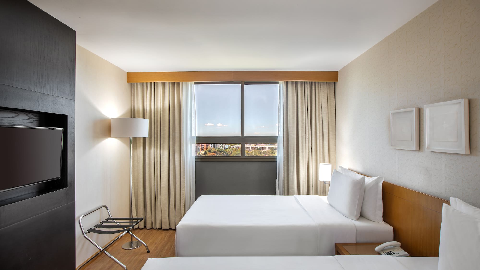 a room with two beds and a chair