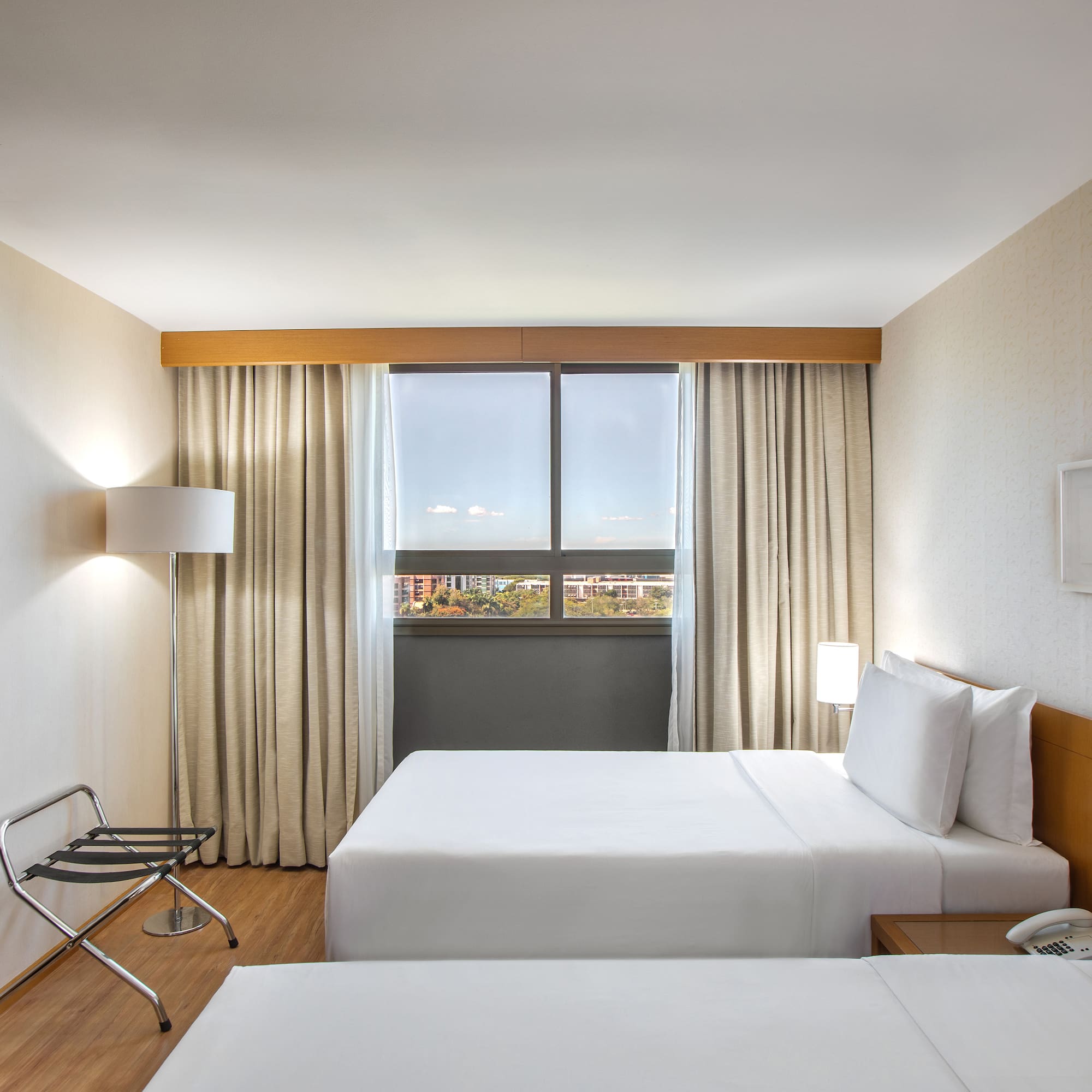 a room with two beds and a chair