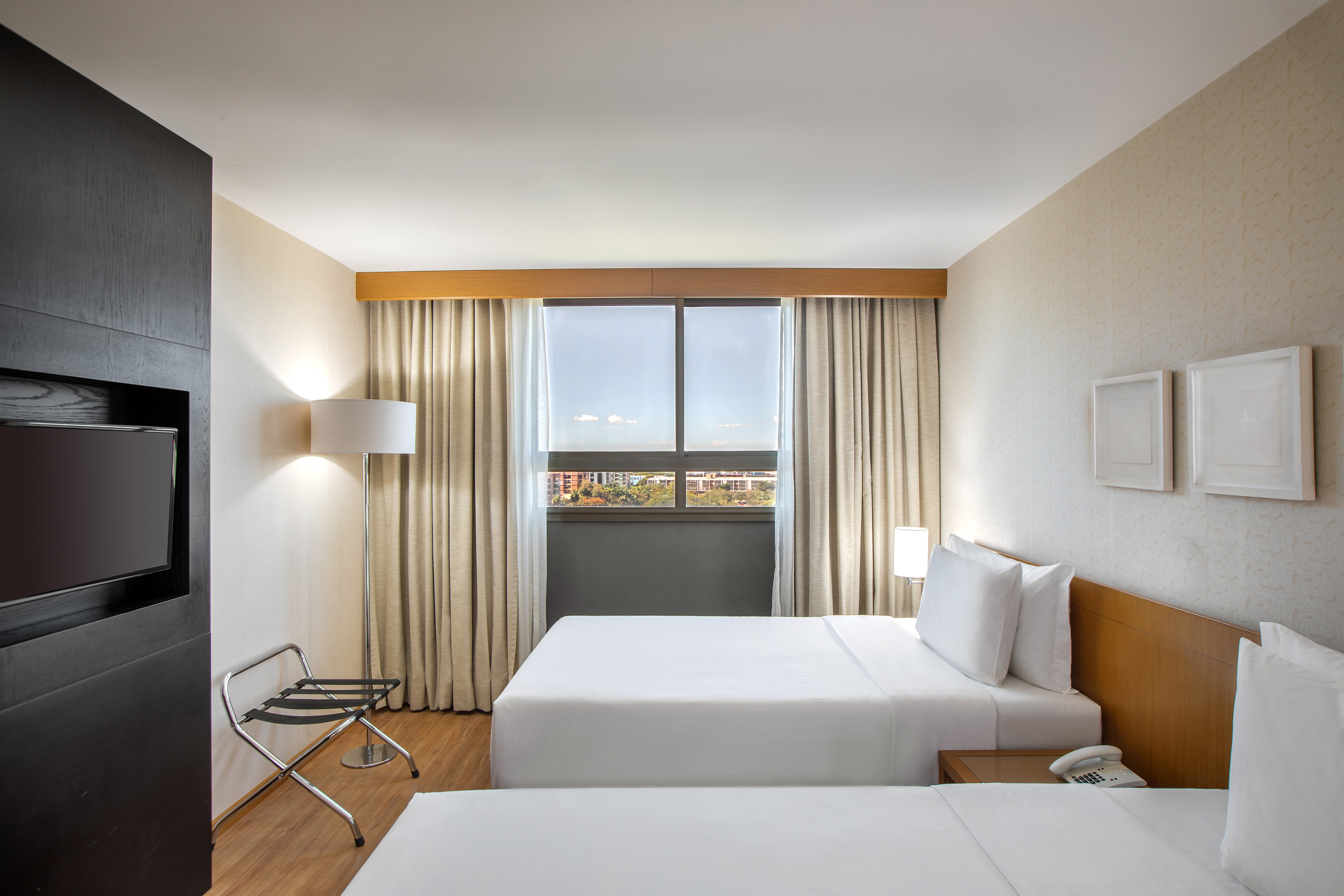 a room with two beds and a chair