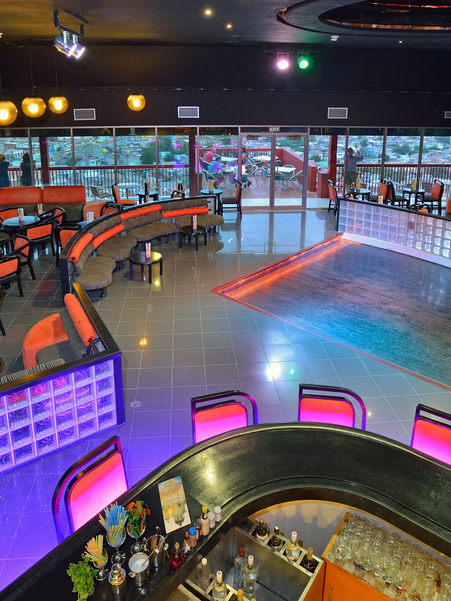 a room with a bar and chairs