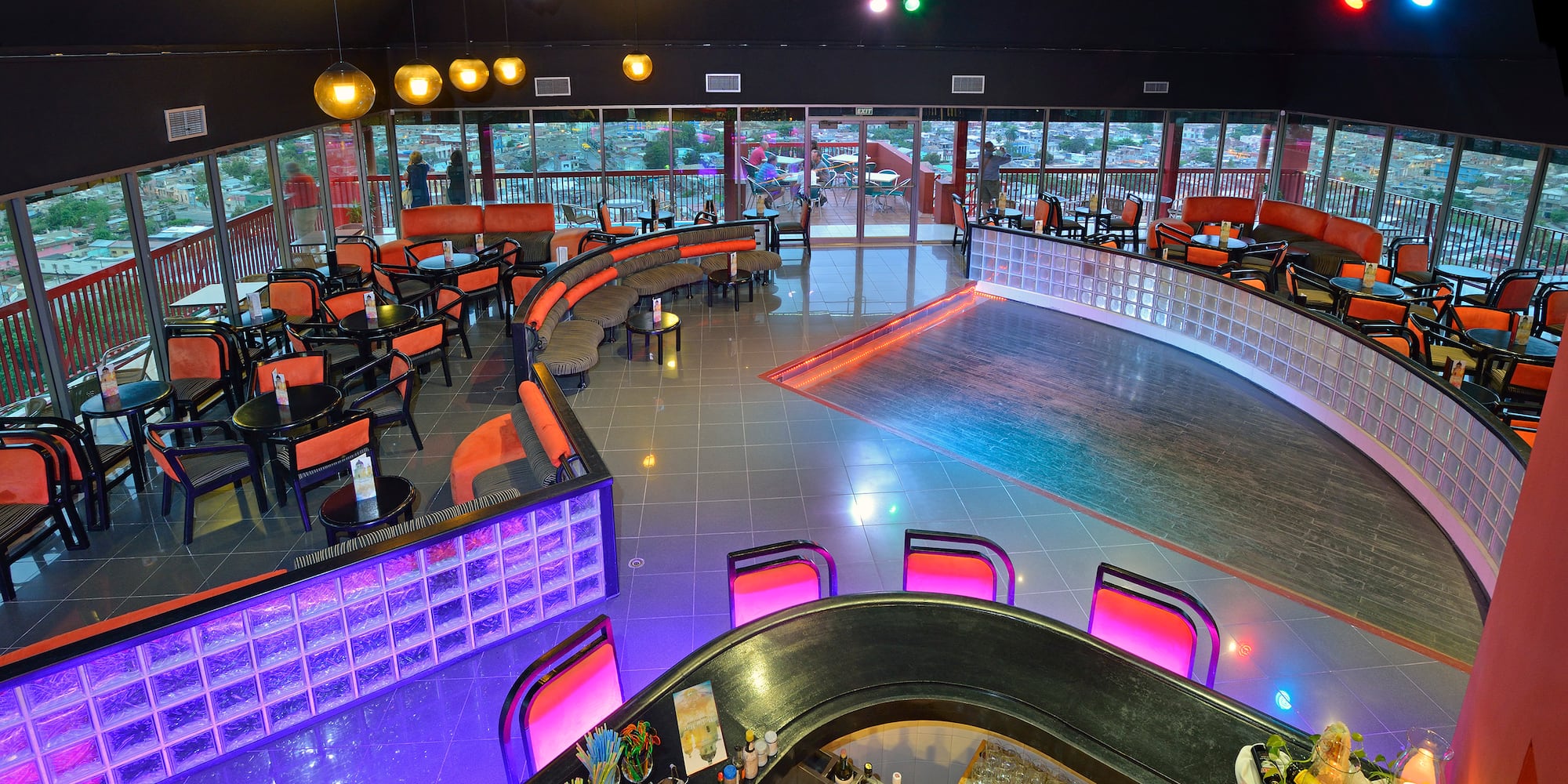 a room with a bar and chairs