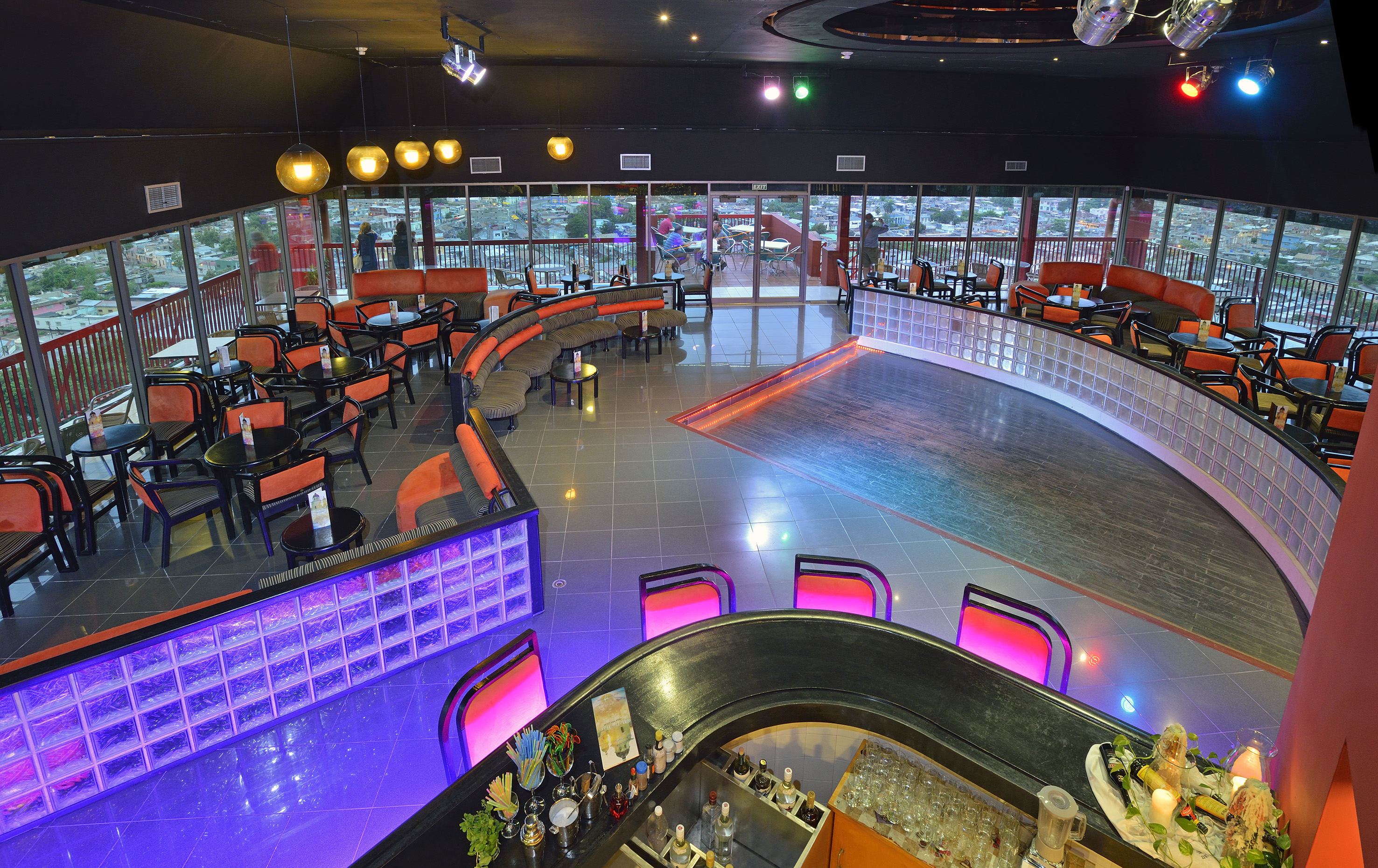 a room with a bar and chairs