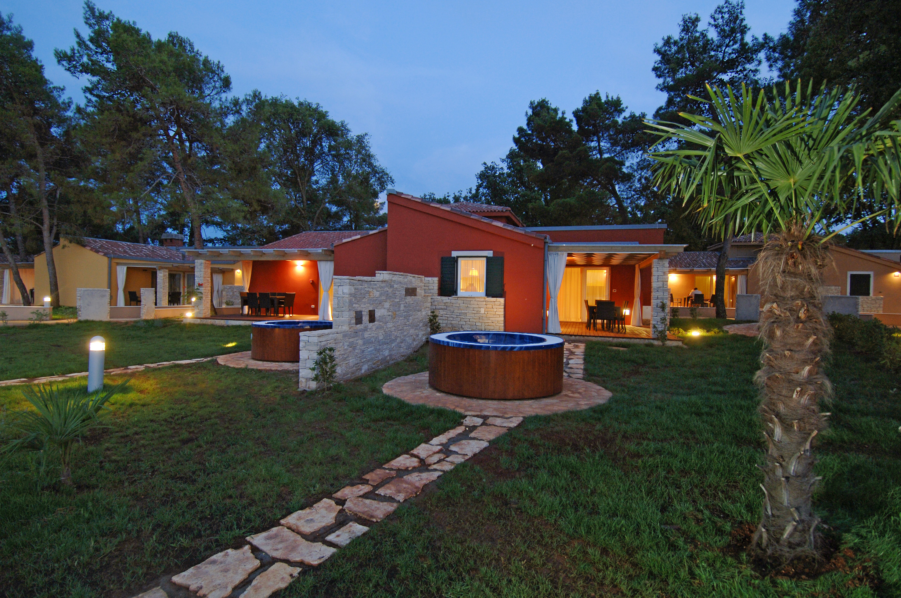a house with a hot tub and a stone walkway