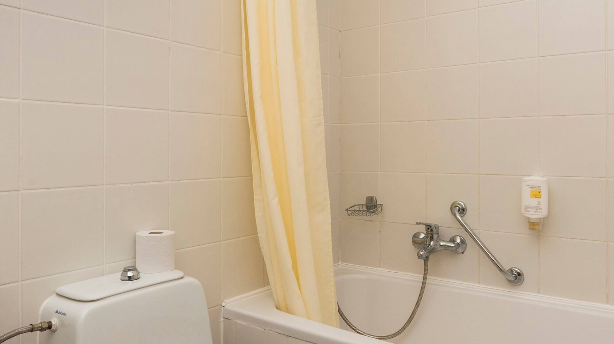 a bathroom with a toilet and bathtub