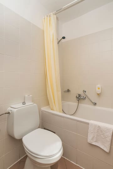 a bathroom with a toilet and bathtub