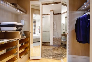 a room with a mirror door and a bathtub