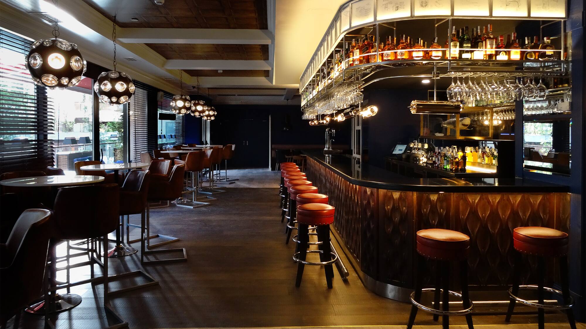 a bar with chairs and a counter