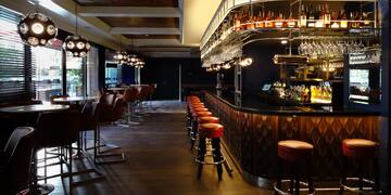 a bar with chairs and a counter