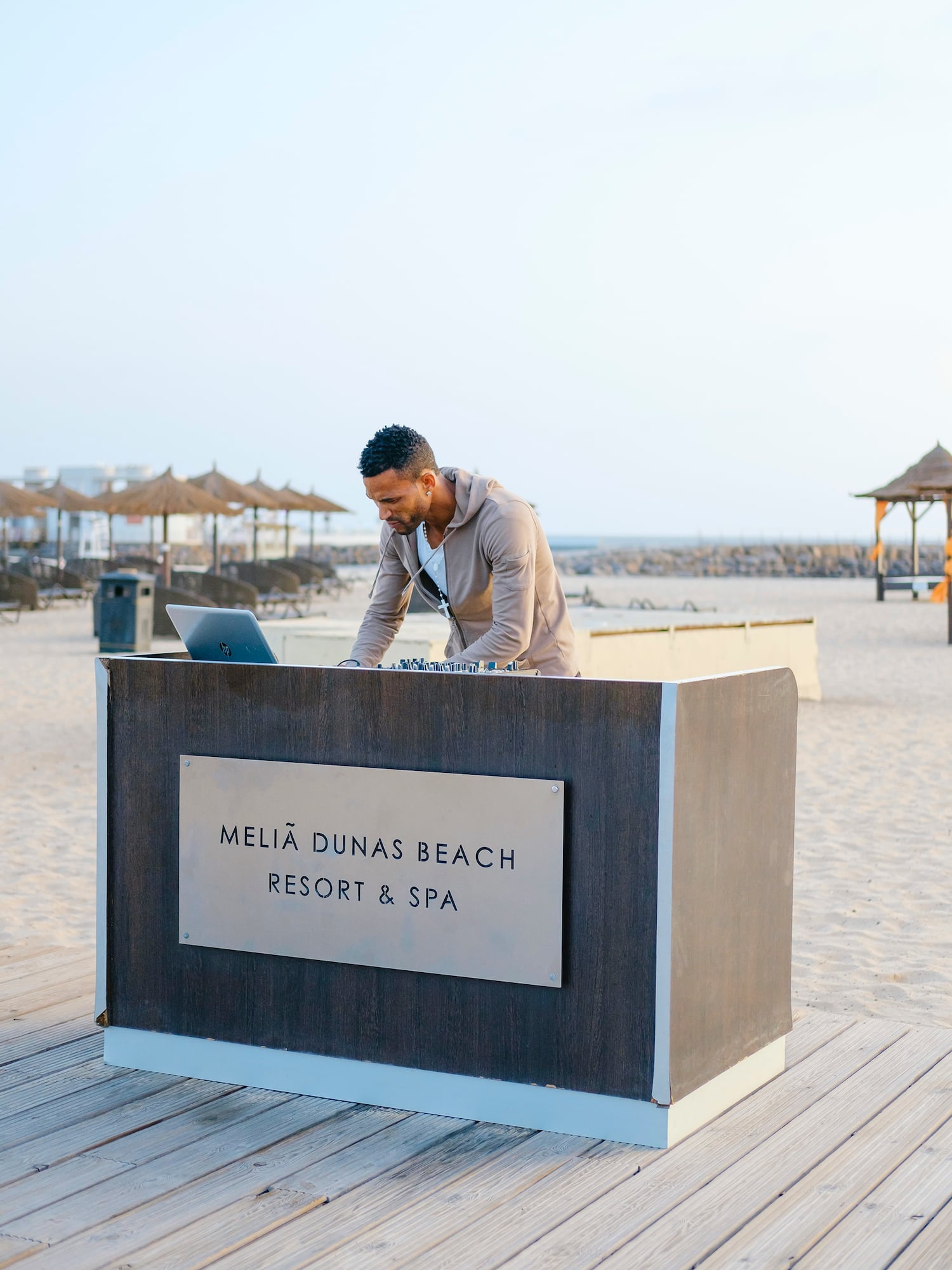 a man standing at a desk on a beach