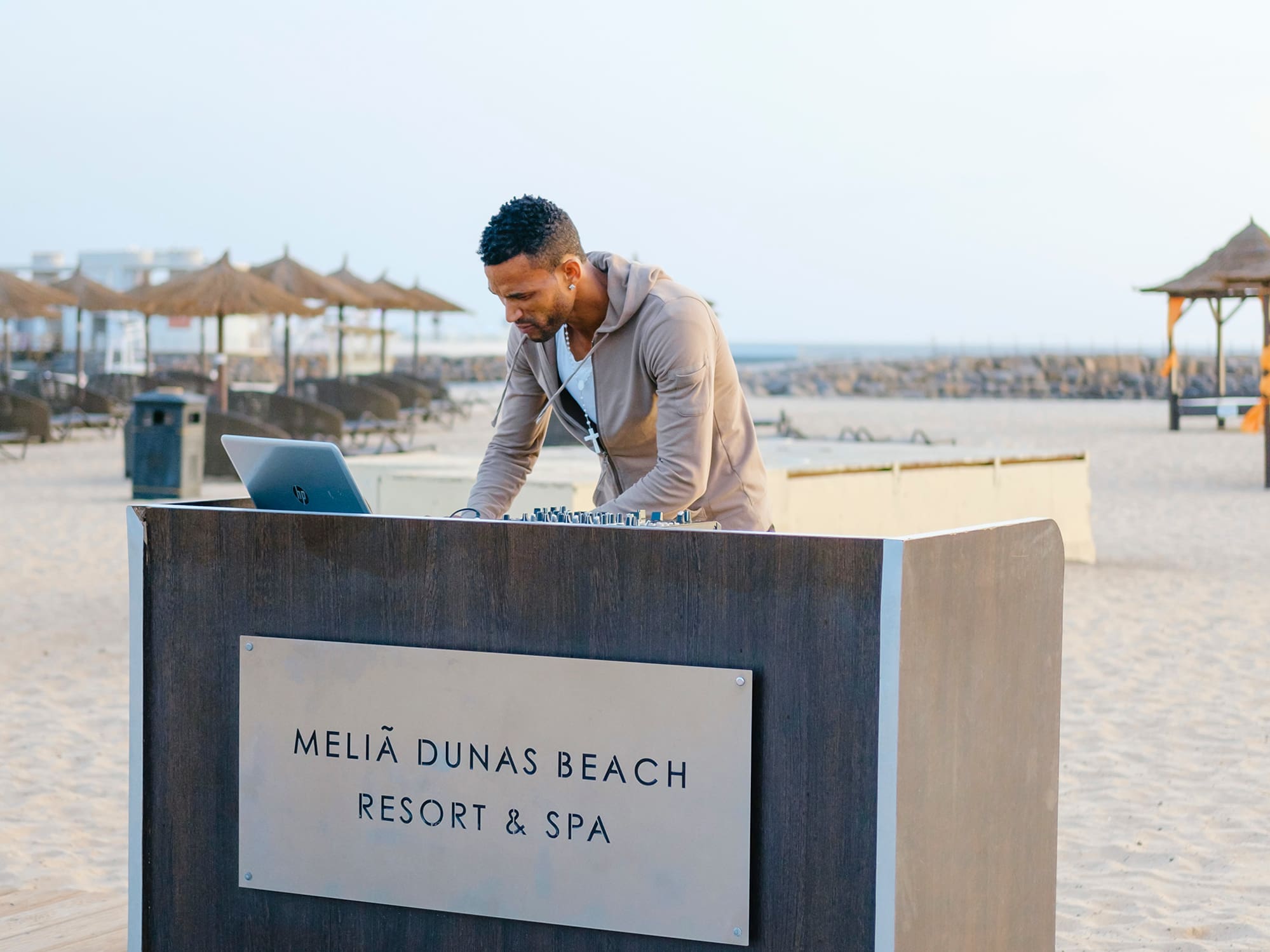 a man standing at a desk on a beach