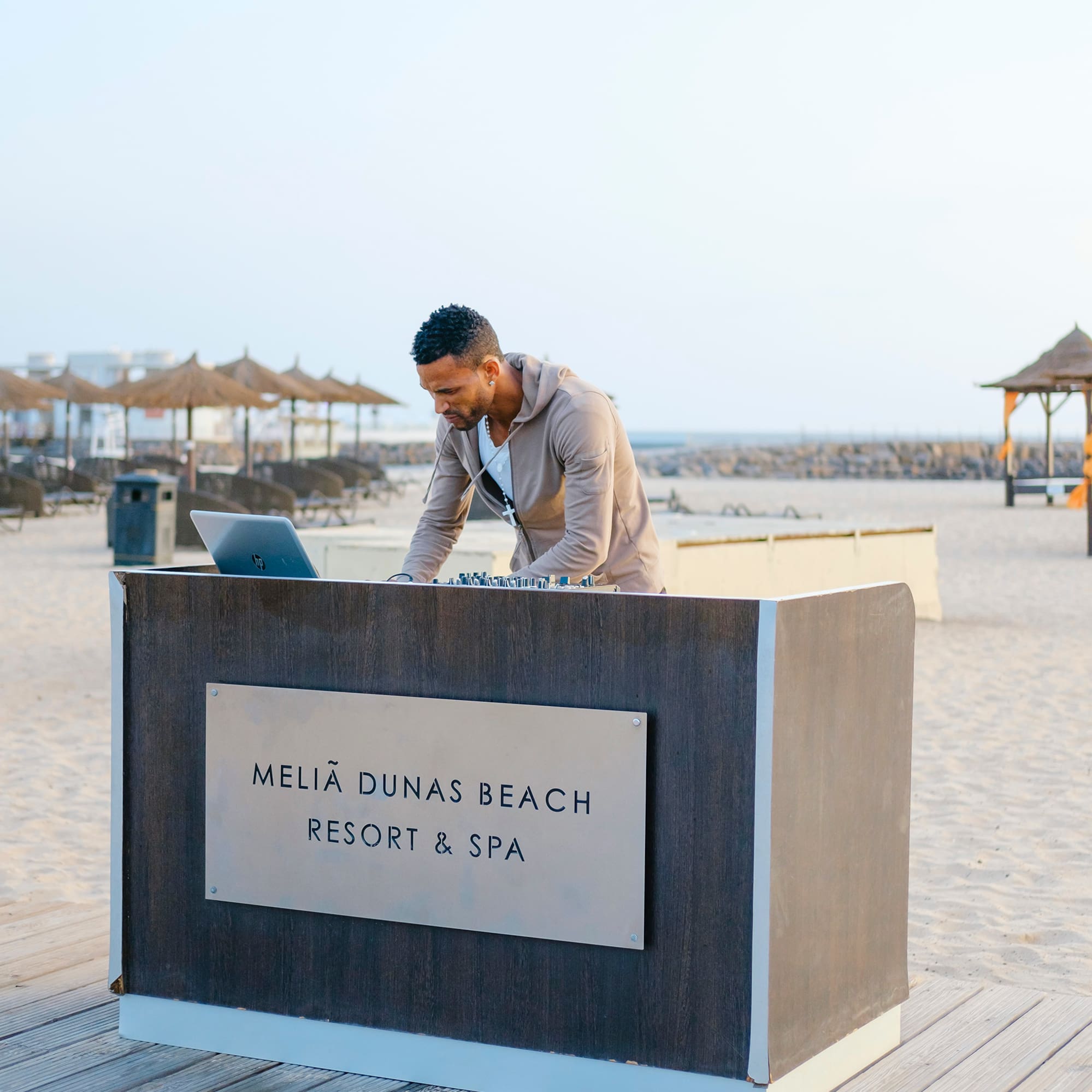 a man standing at a desk on a beach