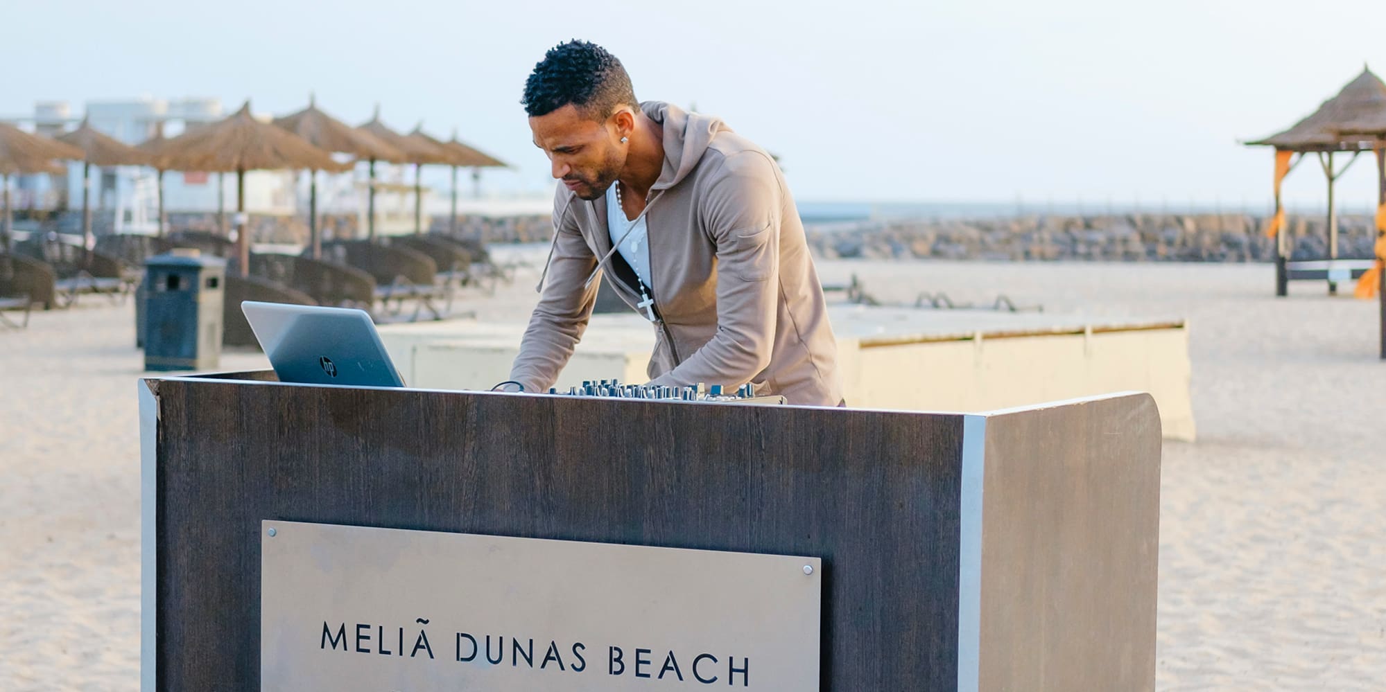 a man standing at a desk on a beach
